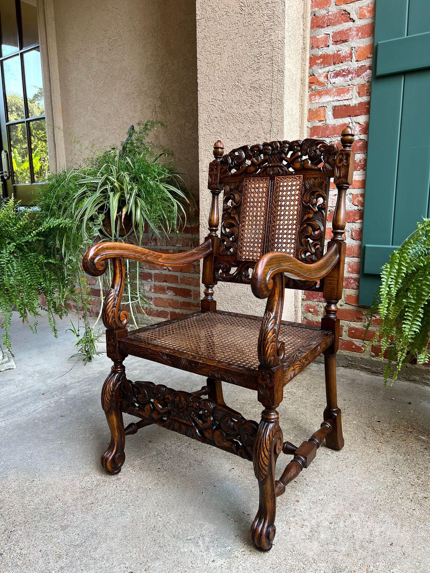 Renaissance Revival Antique English Arm Chair Carved Oak Cane Seat Renaissance Cherubs Fireside For Sale