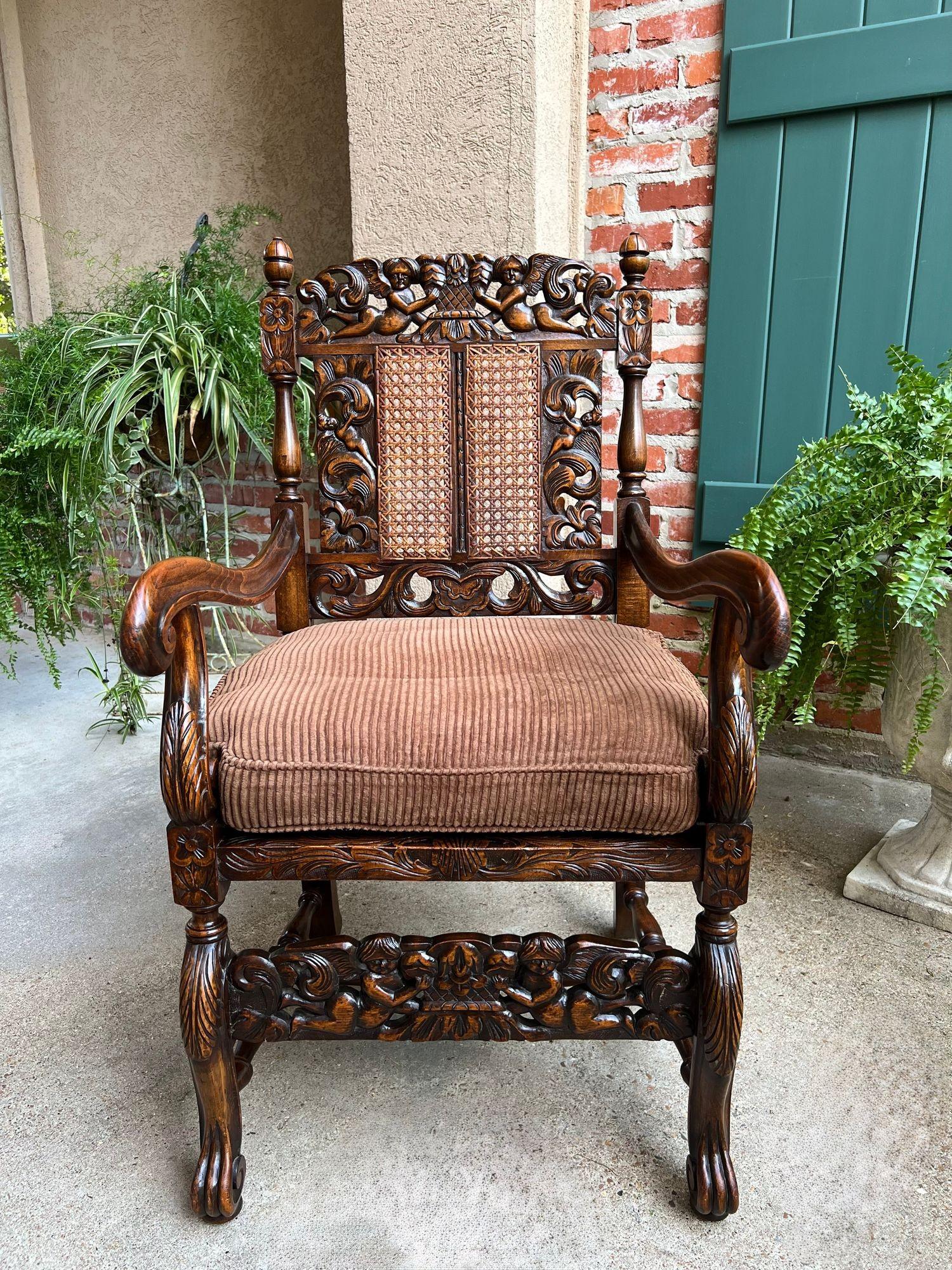 Antique English Arm Chair Carved Oak Cane Seat Renaissance Cherubs Fireside In Good Condition For Sale In Shreveport, LA
