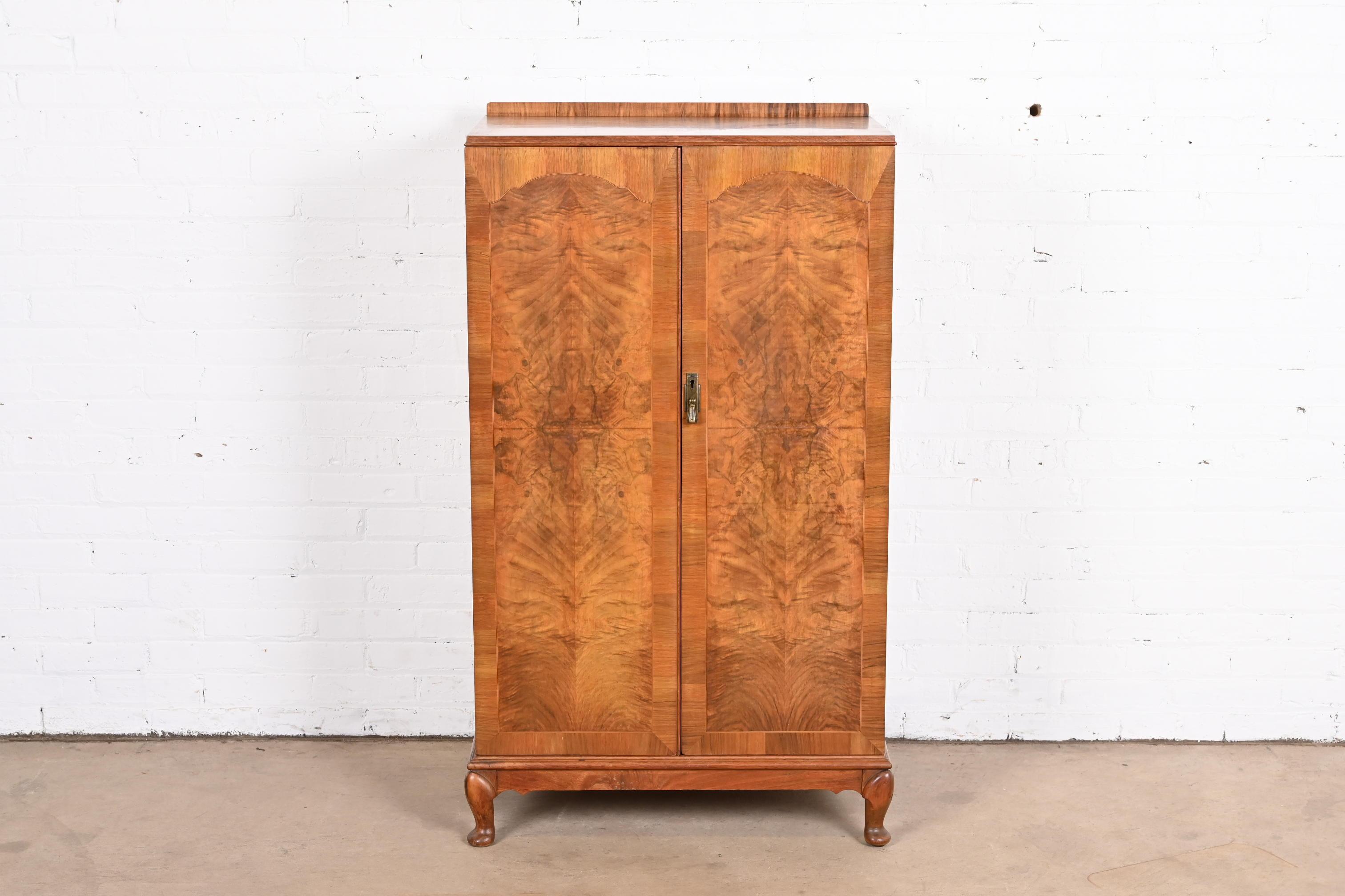 A gorgeous Art Deco gentleman's chest, highboy, or armoire dresser

By Henry Barker Ltd.

England, Circa 1930s

Book-matched burled walnut, with original brass hardware.

Measures: 29.5