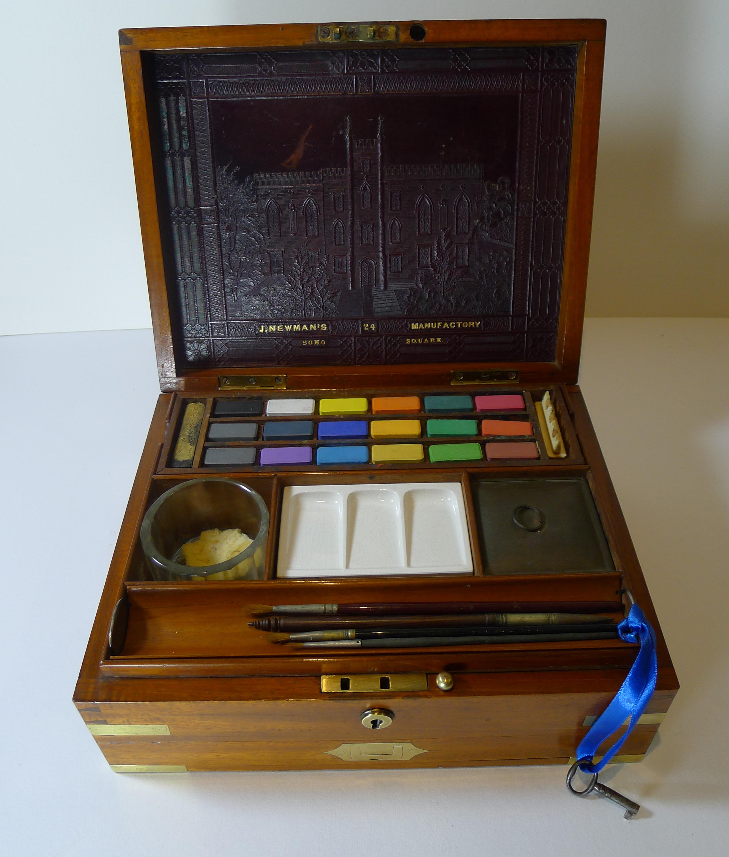 A lovely quality large brass bound Artist's Watercolour box in dating to c.1830.

The box opens to reveal a wonderful red coloured embossed leather panel to the interior of the lid, incorporating the signature of the manufacturer, J. Newman and