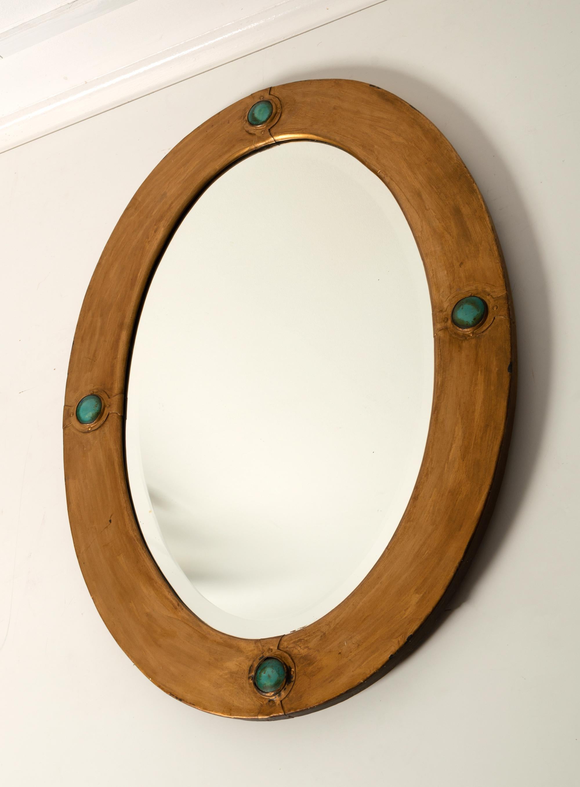 Antique English Arts And Crafts Oval Mirror With Turquoise Cabochons in Riveted Strap Cartouches By Liberty and Co London

In very good condition with minor signs of wear commensurate with age.
please see photos.