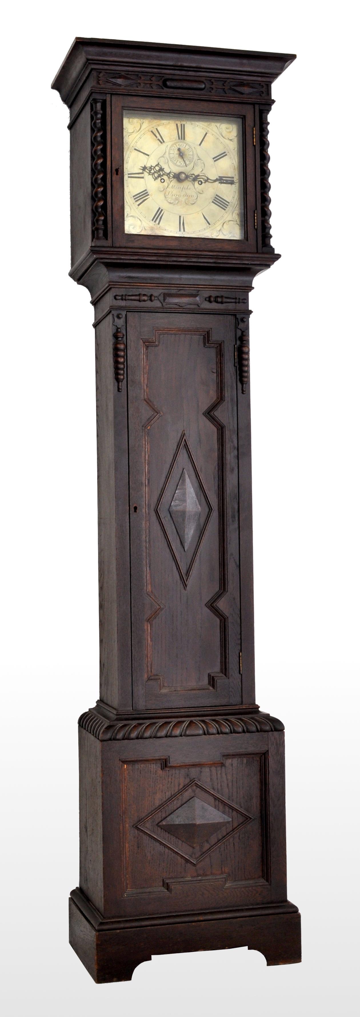 Antique English Arts & Crafts 8-day longcase/grandfather clock by Maple of London, circa 1890. The clock having a carved and ebonized oak case in the William & Mary style, the hood with a pair of barley-twist columns enclosing an engraved brass dial