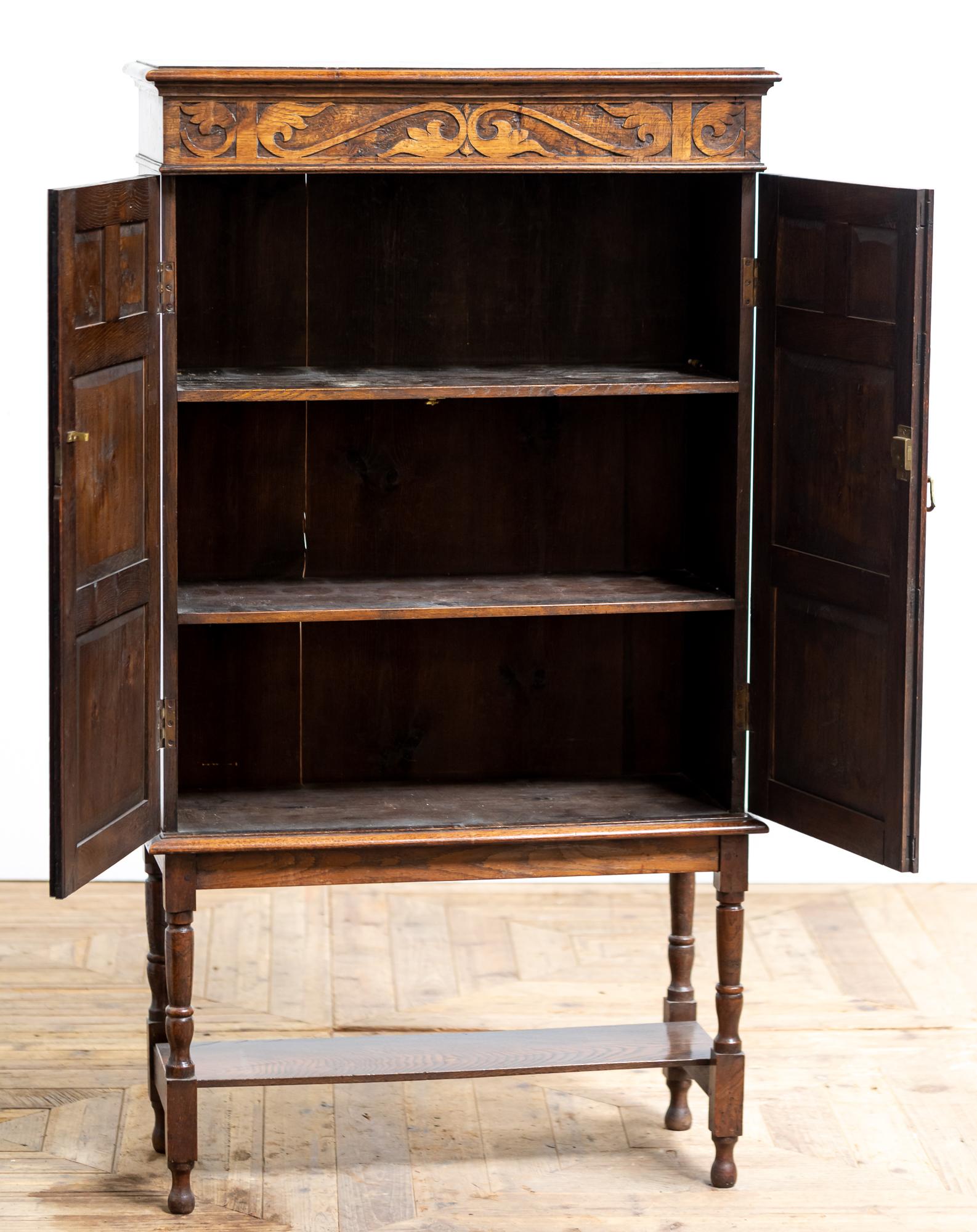 A stunning Arts & Crafts period oak and burr oak cabinet on stand in the style of the early 18th Century. The cabinet has a stunning colour and patina and the door panels have some fantastic figuring to the burr.
  