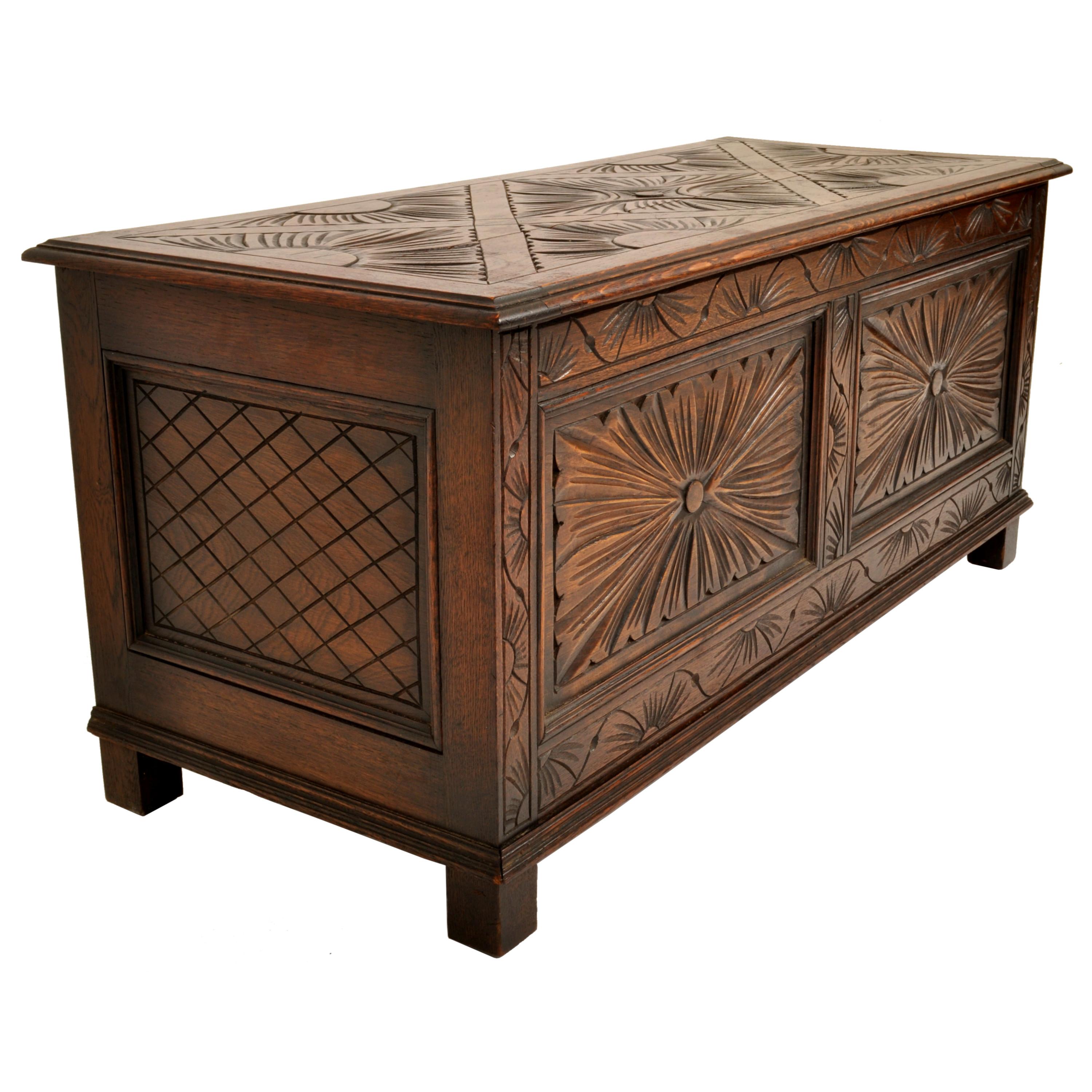 A good English carved oak Arts & Crafts blanket chest, window seat, circa 1900.
The stained oak chest having a hinged lift up lid, the lid is carved with a stylized geometric foliate design, the front of the chest having corresponding carved