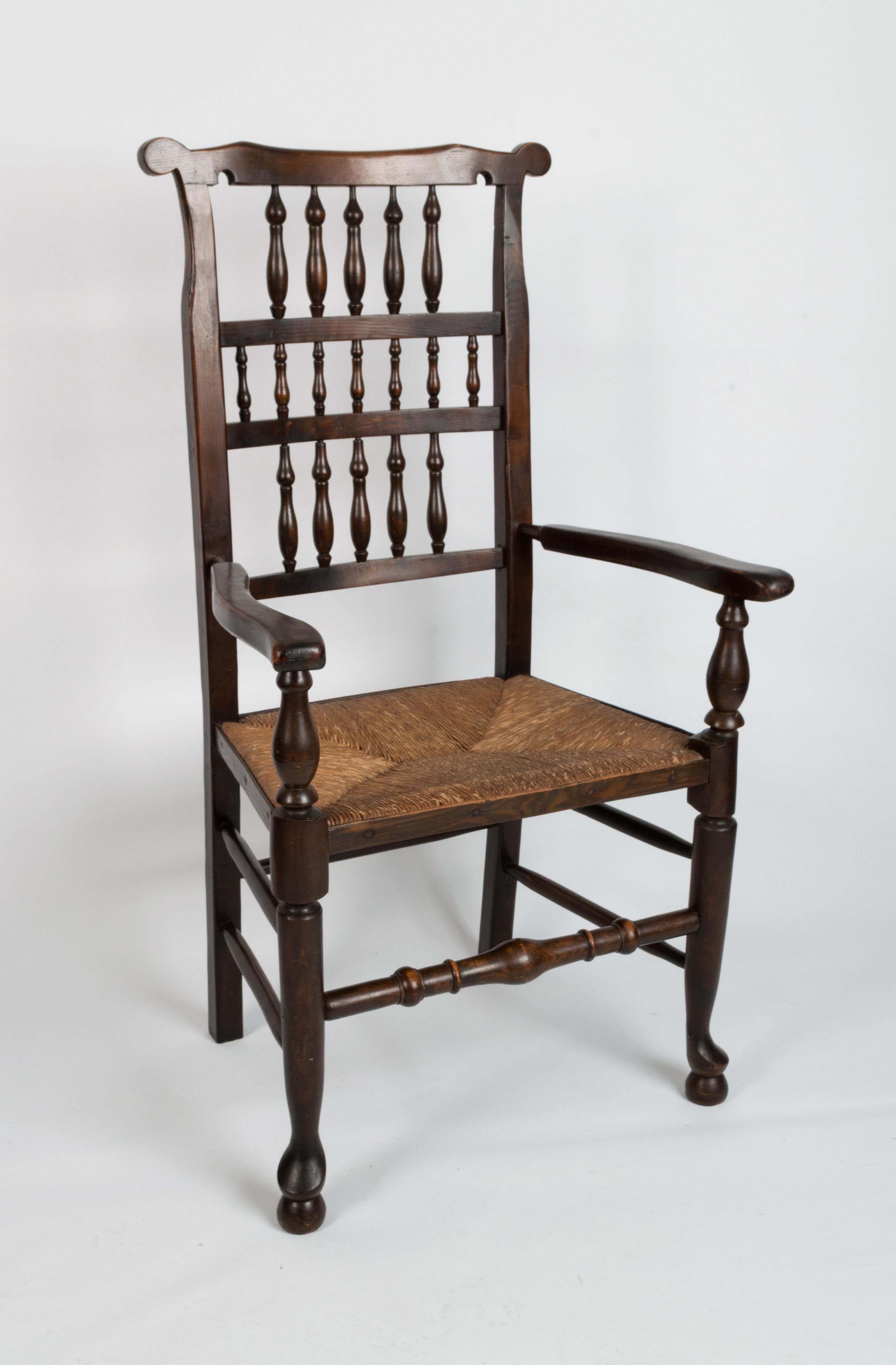 Antique English Arts & Crafts Oak Rush Elbow Chair C.1840

A 19th Century Lancashire Spindle back Hall Chair .
England, C.1840
Turned oak, 17 spindle back splat with rush seat.

Excellent solid and sturdy condition commensurate of age. Historic