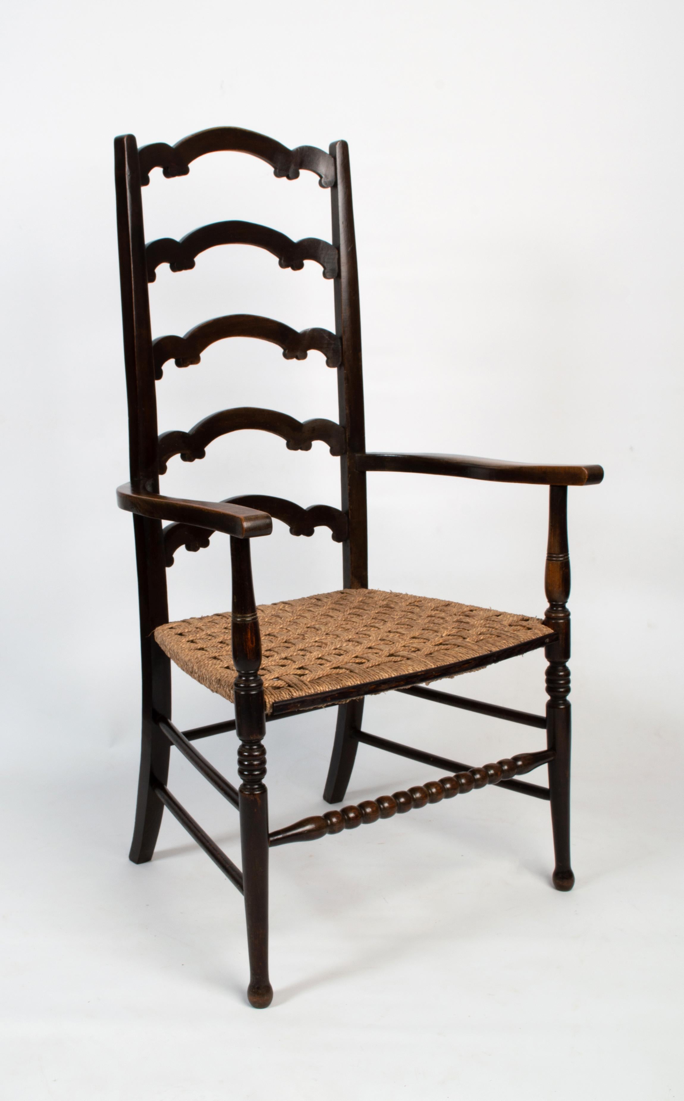 Antique English Arts & Crafts William Birch Liberty & Co. Elbow Chair.
circa1890
Very good solid condition commensurate of age. Later replaced raffia seat.