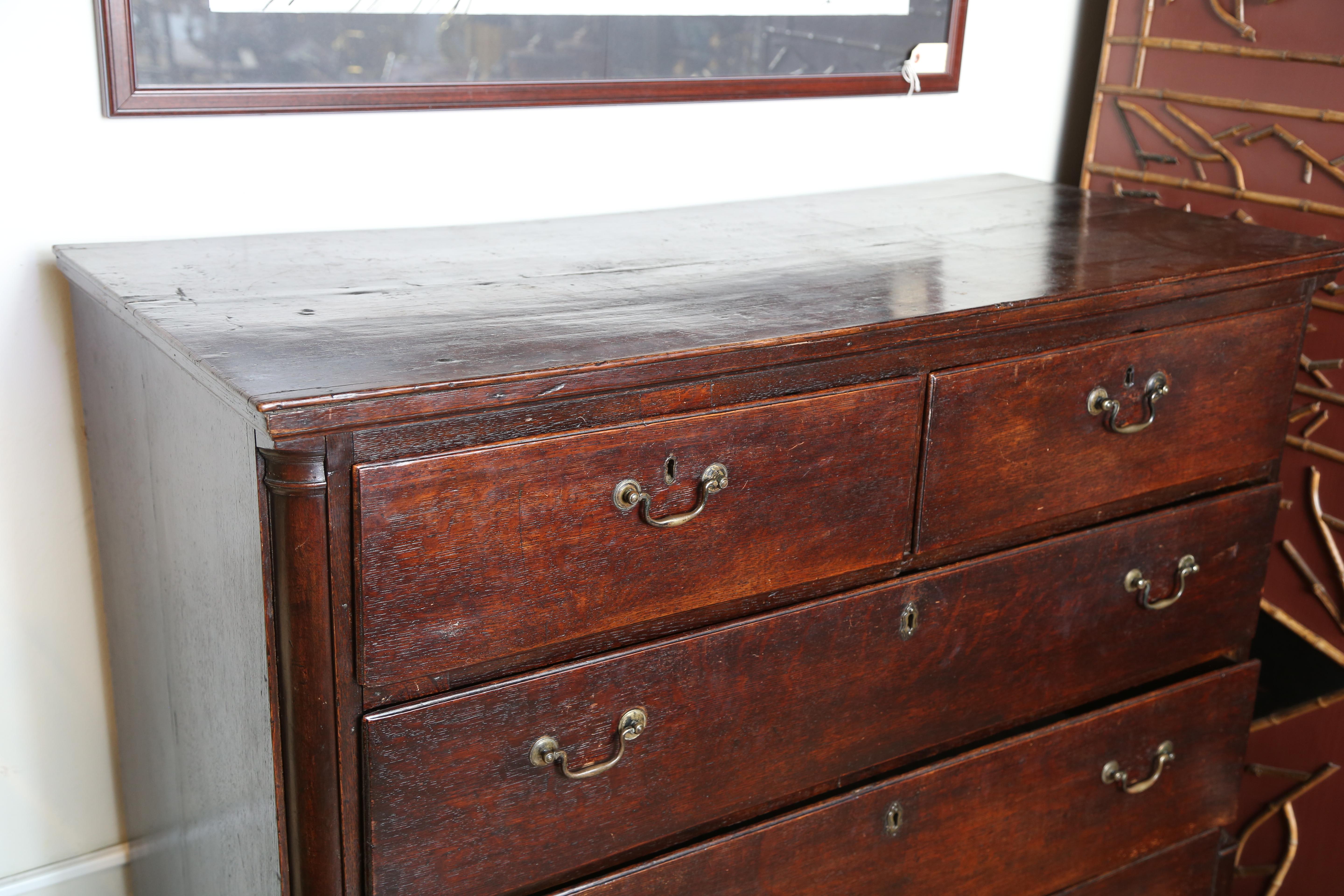 Eighteenth century English Chippendale chest of drawers consisting of two small drawers over three large ones. Original antique hardware.