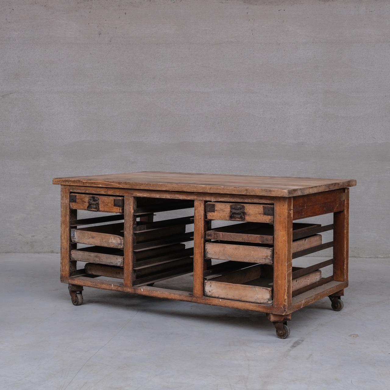 An early 20th century Bakers table.

England, c1920s.

The top is a slight bow in it. But could be equally replaced with a marble top to make it more suitable or matching to use as a kitchen island.

Antique condition, scuffs and wear commensurate