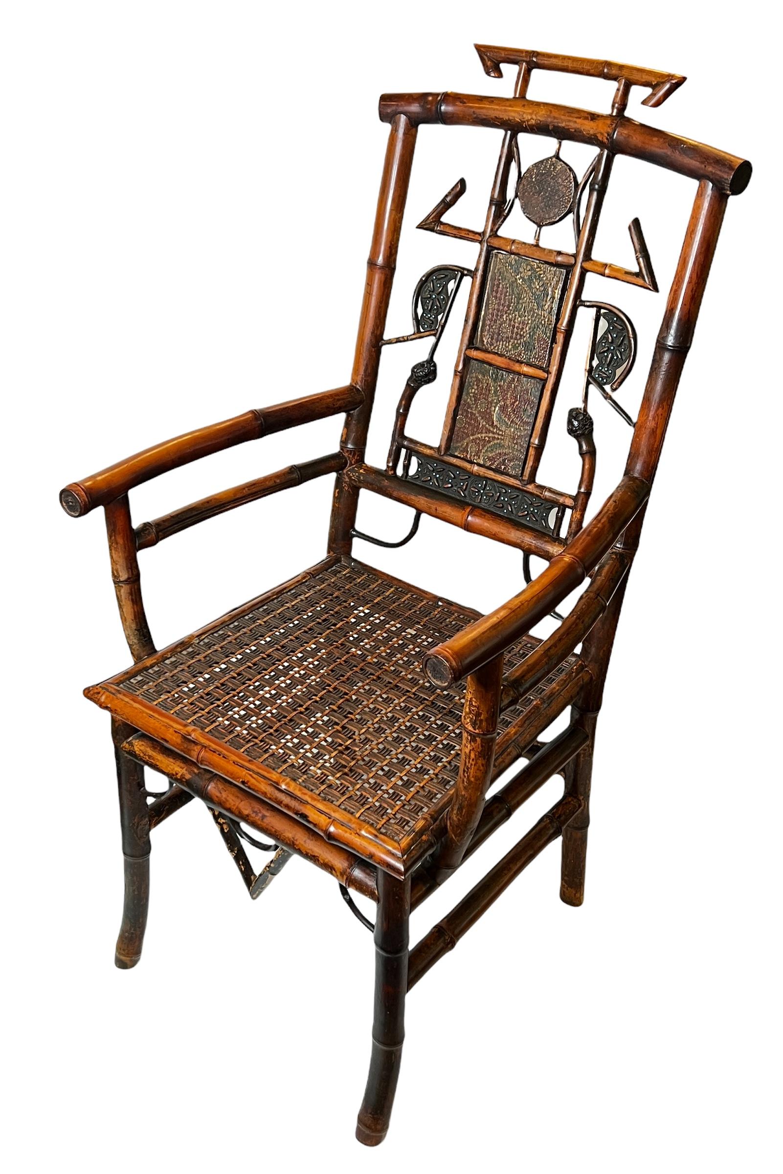 Our antique English bamboo armchair features a rattan seat and seatback with lovely embossed and painted leather panels. In excellent condition with a fine patina reflecting the chair's age.