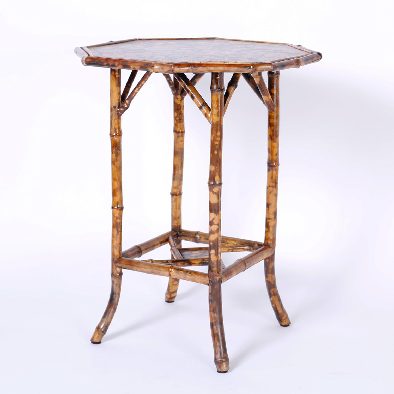 Antique English bamboo occasional table or stand with an octagon top ingeniously decorated with contemporary decoupage seashells.