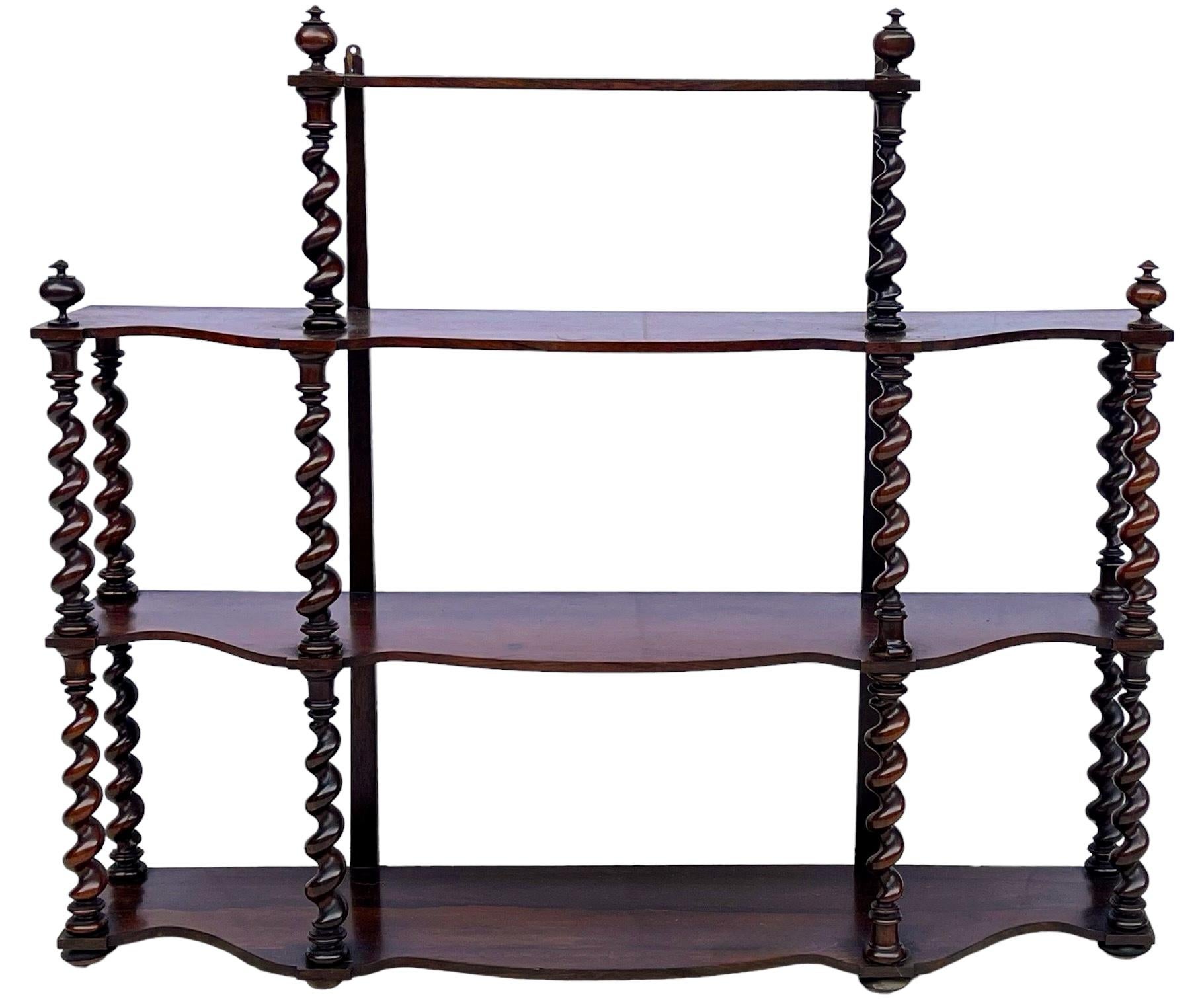 This is a late 19th century large scale English wall shelf with barley twist supports. It is in very good condition for its age. Proper anchoring is recommended for mounting. 

To the top shelf is 29” without the finial. 
Three shelves are 8” deep,