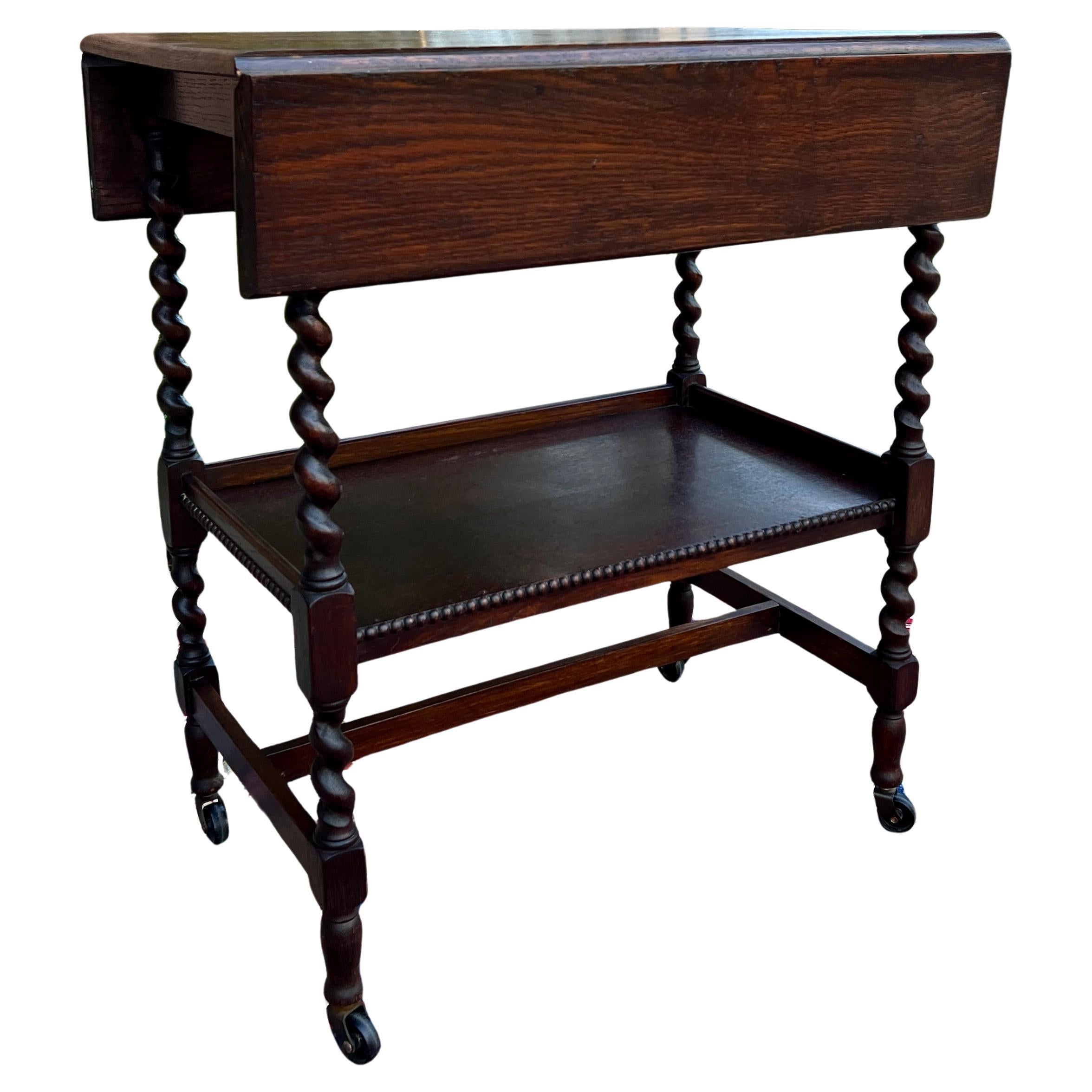 Wonderful Antique English Dark Oak Barley Twist Drop Leaf Tea/Pastry Cart or End Table Side Occasional Table~~Square Top When Open~~c. 1930s

Drop leaf sides with spin top
 

        Versatile size~~31.5
