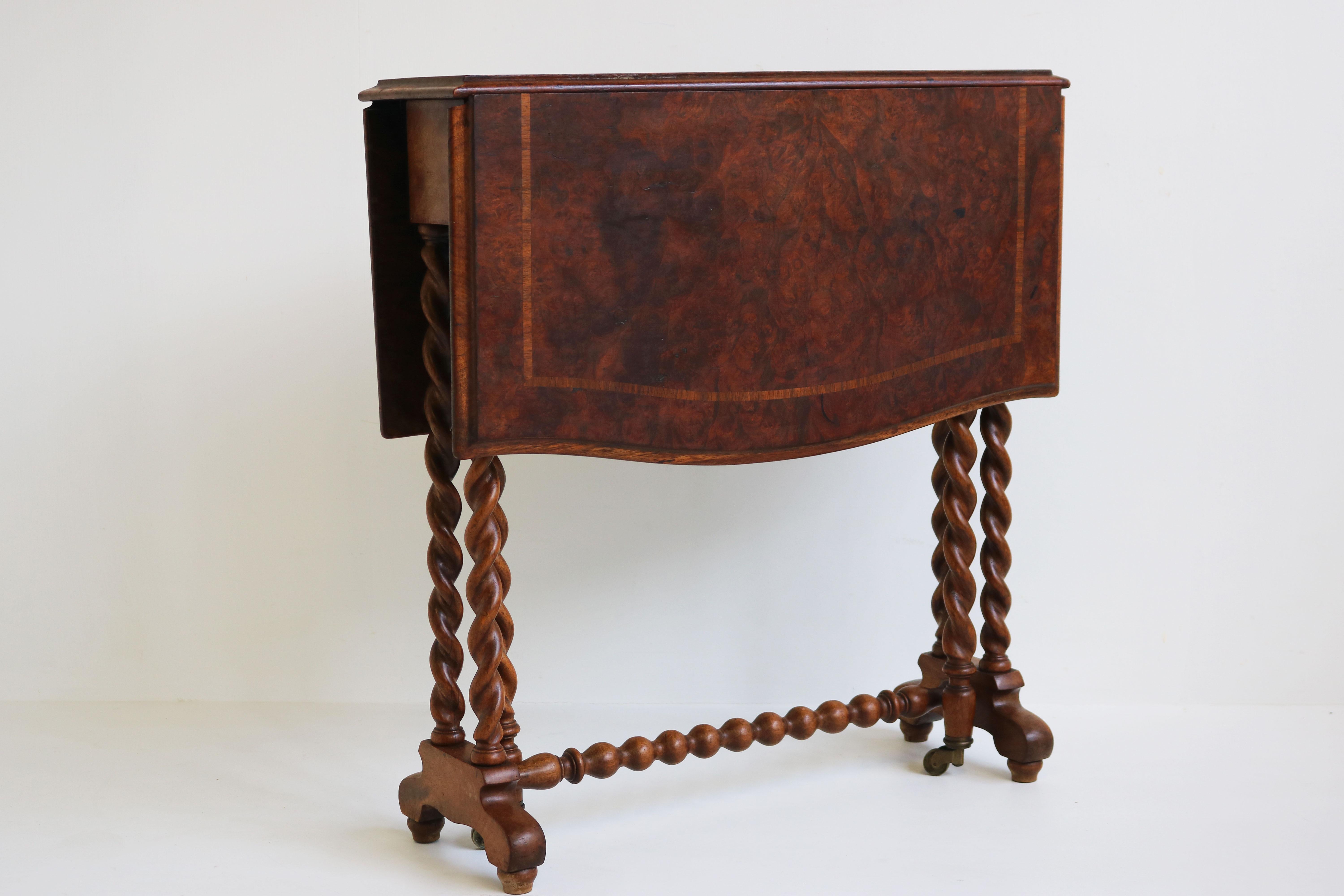 Gorgeous English 19th century barley twist gateleg / foldable table with inlaid top.
 Very nice walnut burl top with inlaid trim. Folds smoothly with its brass wheels.
Amazing quality all solid wood & gorgeous original condition.
Very practical &