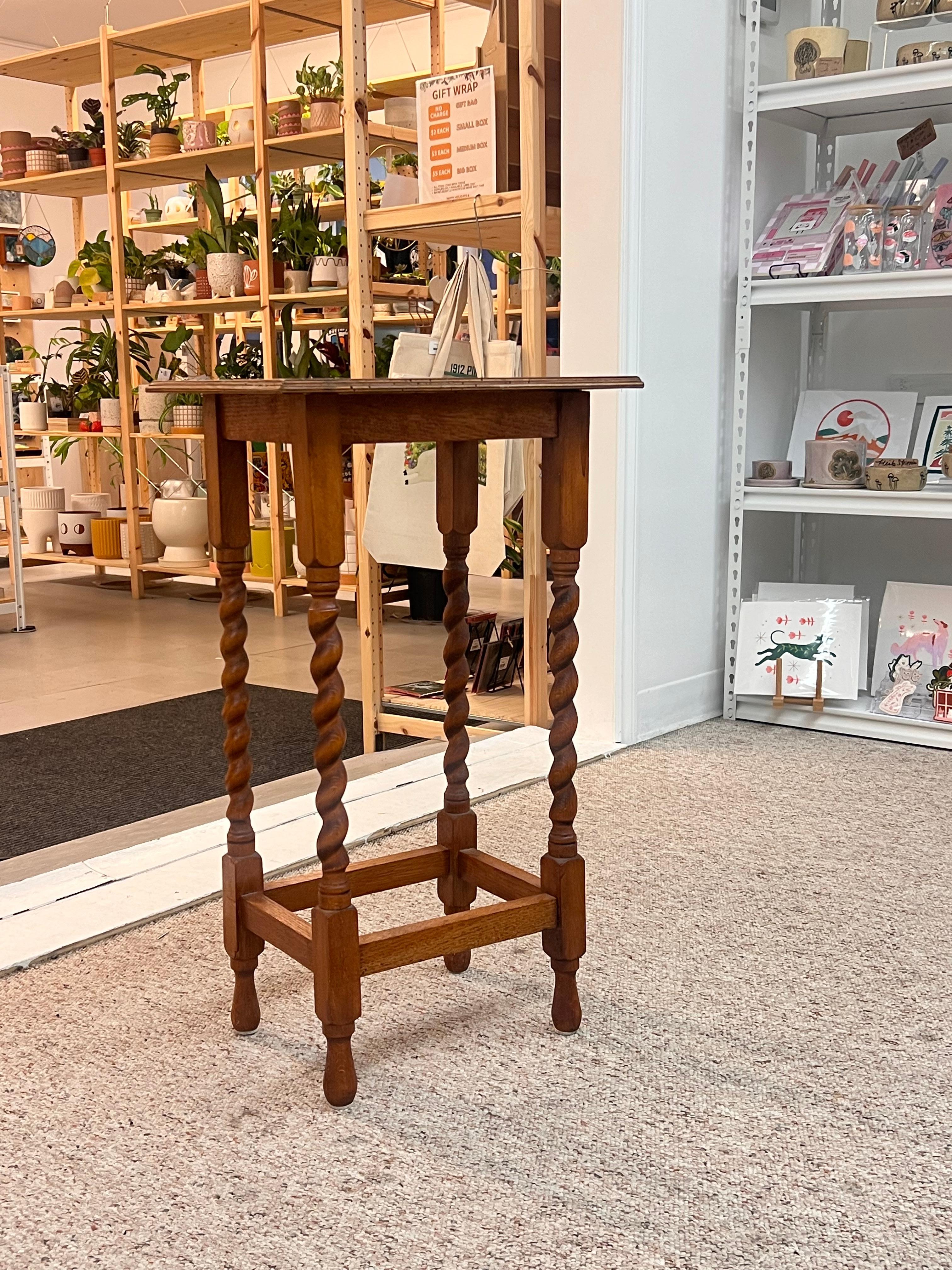 This antique English barley twist side table is a classic piece of furniture that showcases traditional craftsmanship and design. Made from high-quality wood, such as oak and feature intricately twisted legs that resemble barley stalks. The rich