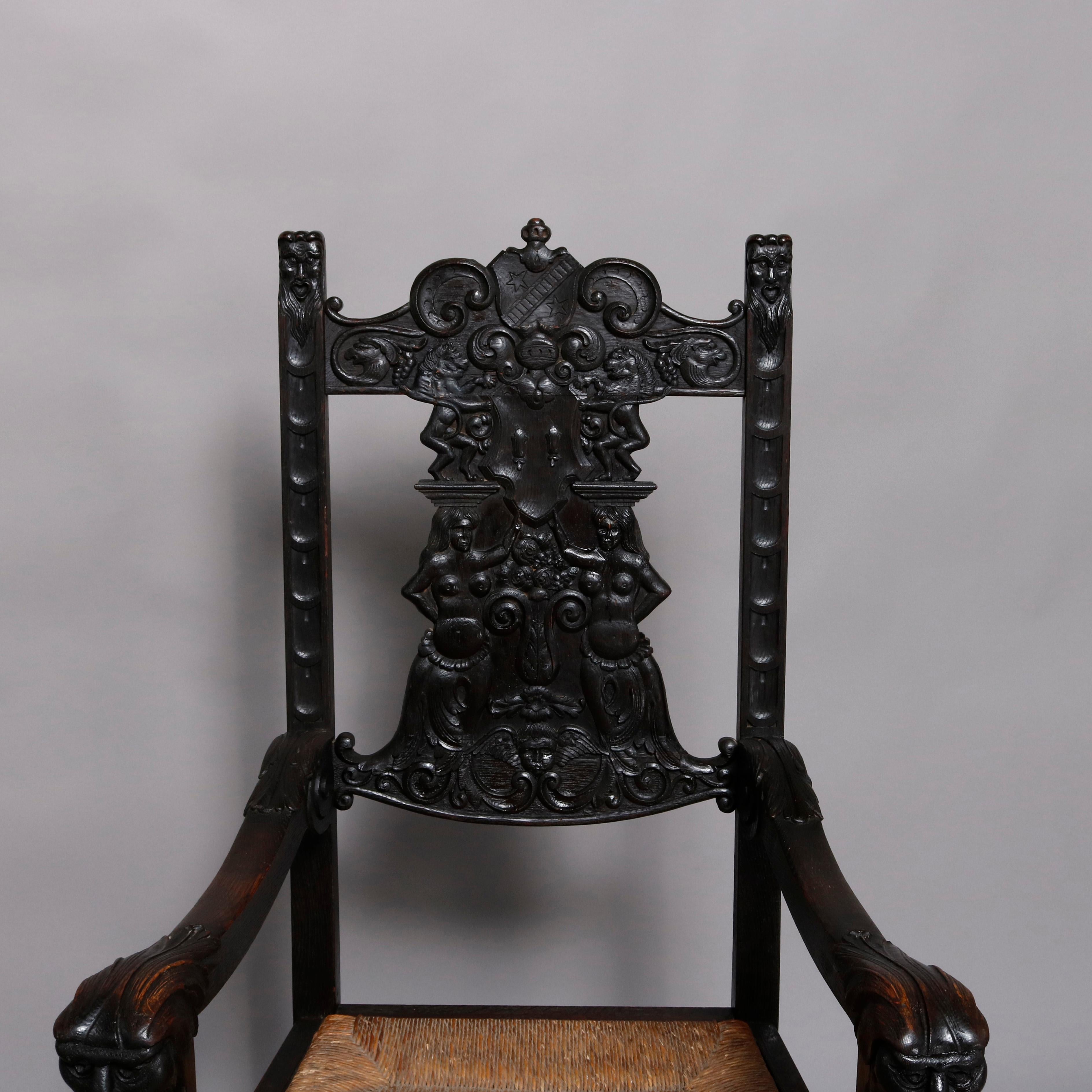 An antique English Baroque throne chair offers heavily carved oak construction with all-over foliate and scroll decoration with slat back flanked by supports and scroll form arms terminating in carved masks, and with woven rush seat, circa