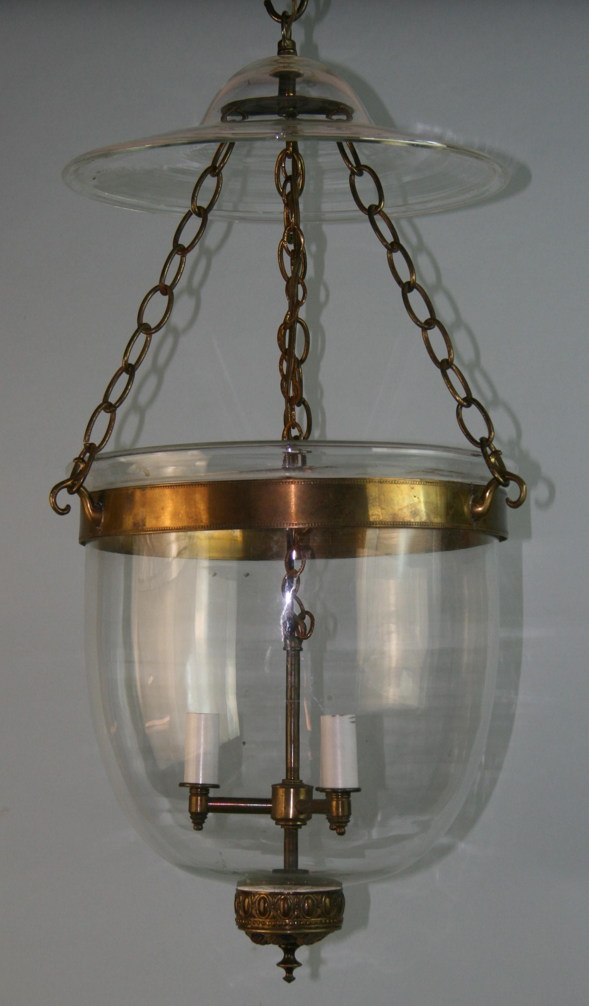 1263 English three light antique bell jar lantern with bronze detailing at base.