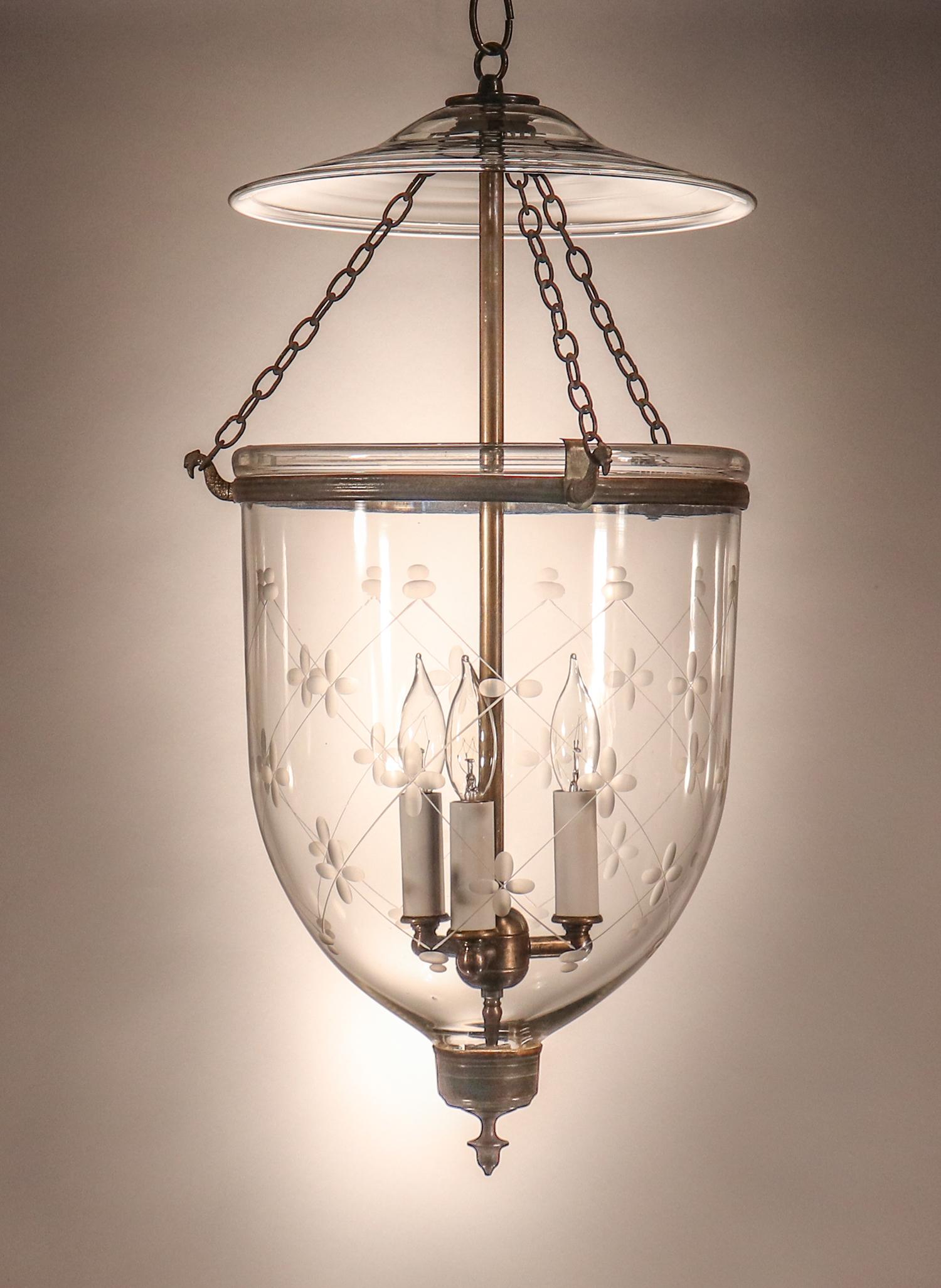 An antique English bell jar lantern manufactured in England, circa 1860, with all-authentic brass fittings. The quality of this hand blown glass lantern is excellent, with several visible air bubbles. In addition, an etched 