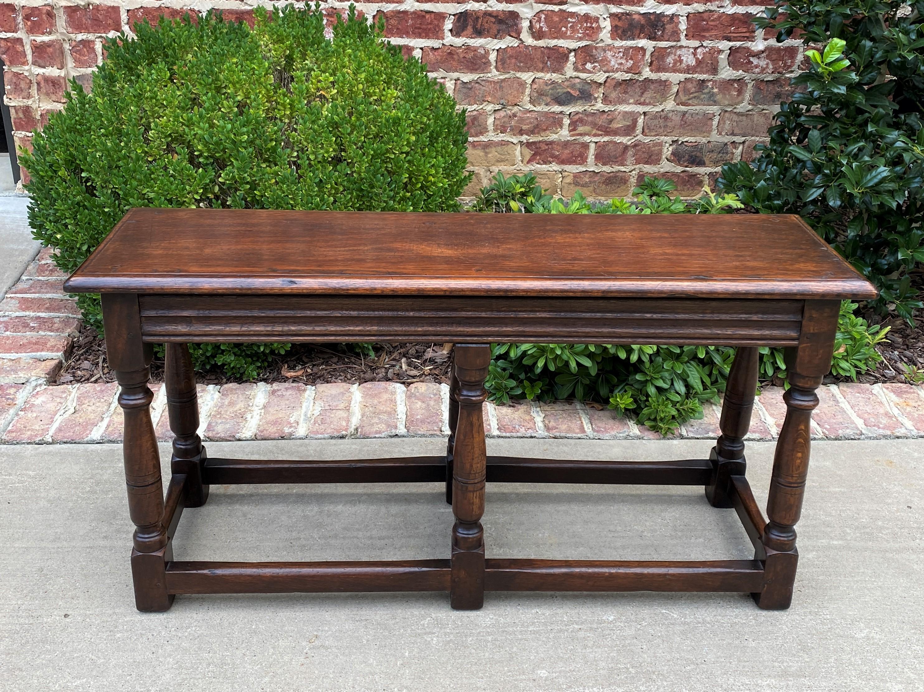 Charming antique English oak bench or stool~~Pegged Construction~~c. 1920s

Classic British flair decorator piece~~beveled edge top with turned post legs and sturdy stretcher~~old pegged construction~~always in high demand!

Perfect for a living