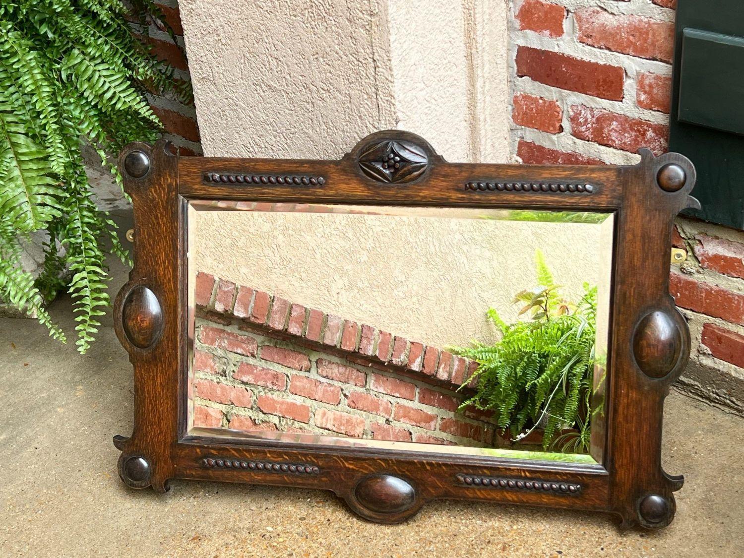 Antique English Beveled Wall Mirror Carved Oak Frame Jacobean Arts & Crafts.

Direct from England, another fabulous antique English wall mirror!  The large rectangular frame features a wide, dark oak band with beaded trim, and large oval medallions