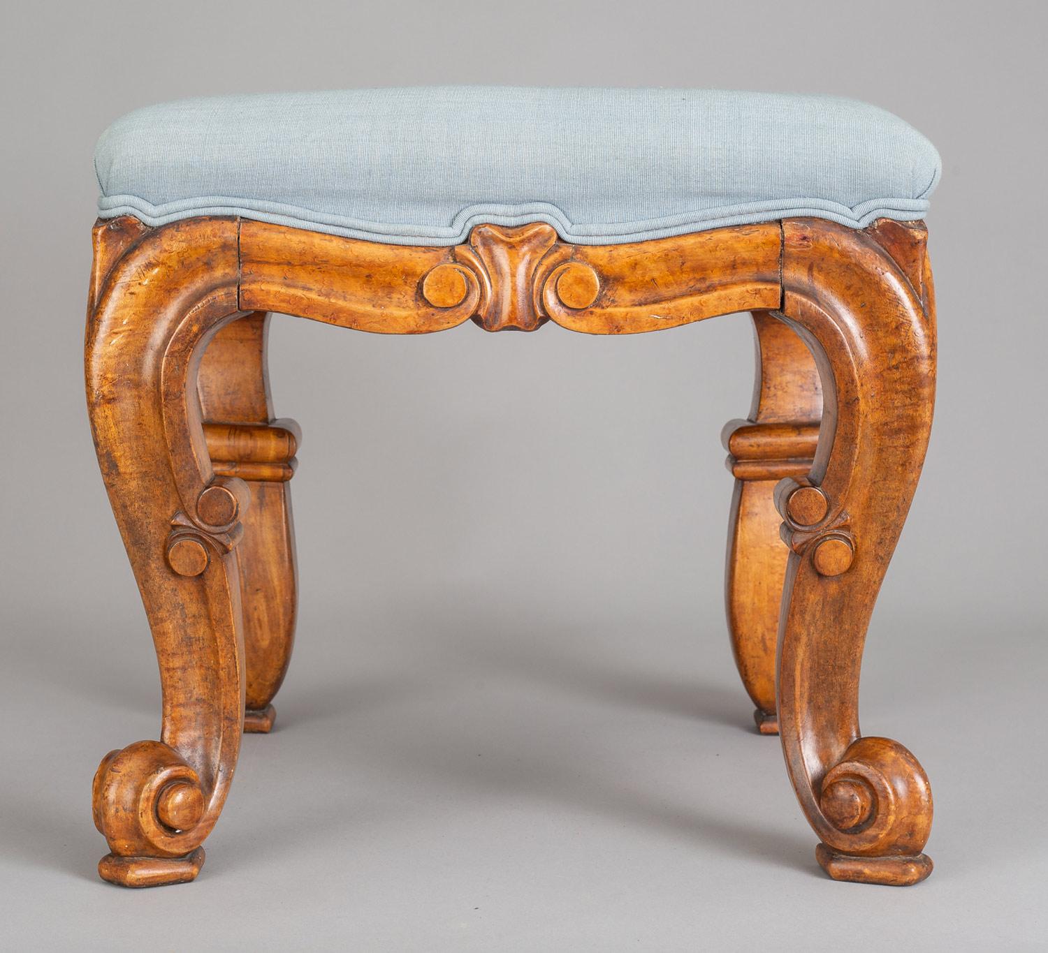 Early Victorian carved and molded bird’s eye maple stool with cabriole legs ending in scroll feet on pads. Upholstered in pale blue silk twill. Makers label on underside: G. Parkhurst & Co., Cabinet Makers, Haywards Heath.