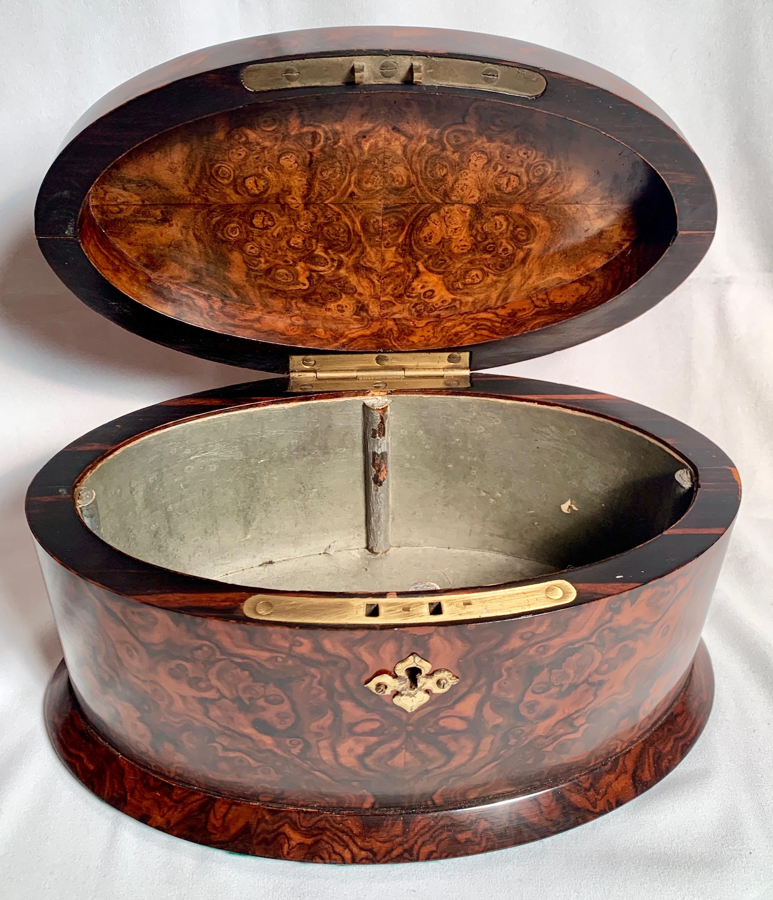 This is an exquisite black walnut tea caddy. It is in excellent condition and has a beautiful finish.
 