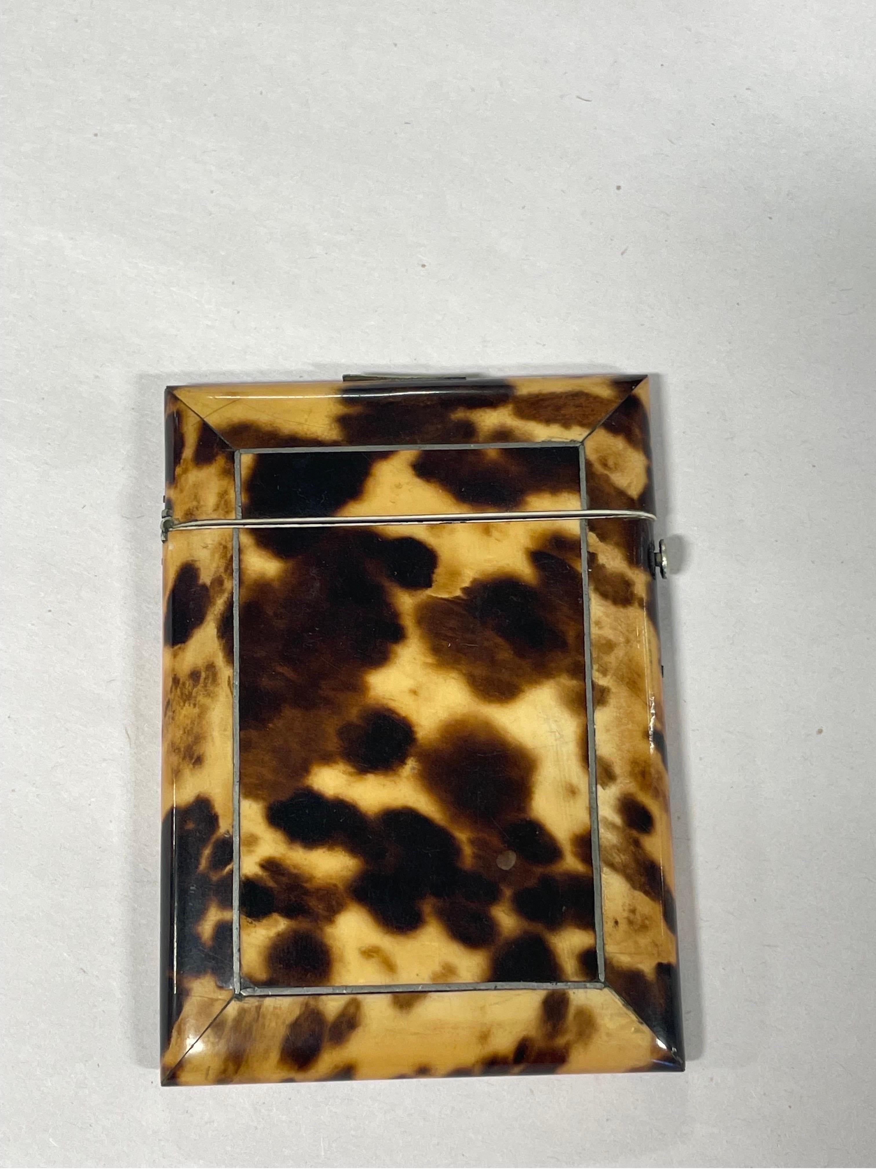 An Antique English blonde tortoiseshell card holder with locking hinge. Monogrammed to silver plaque.