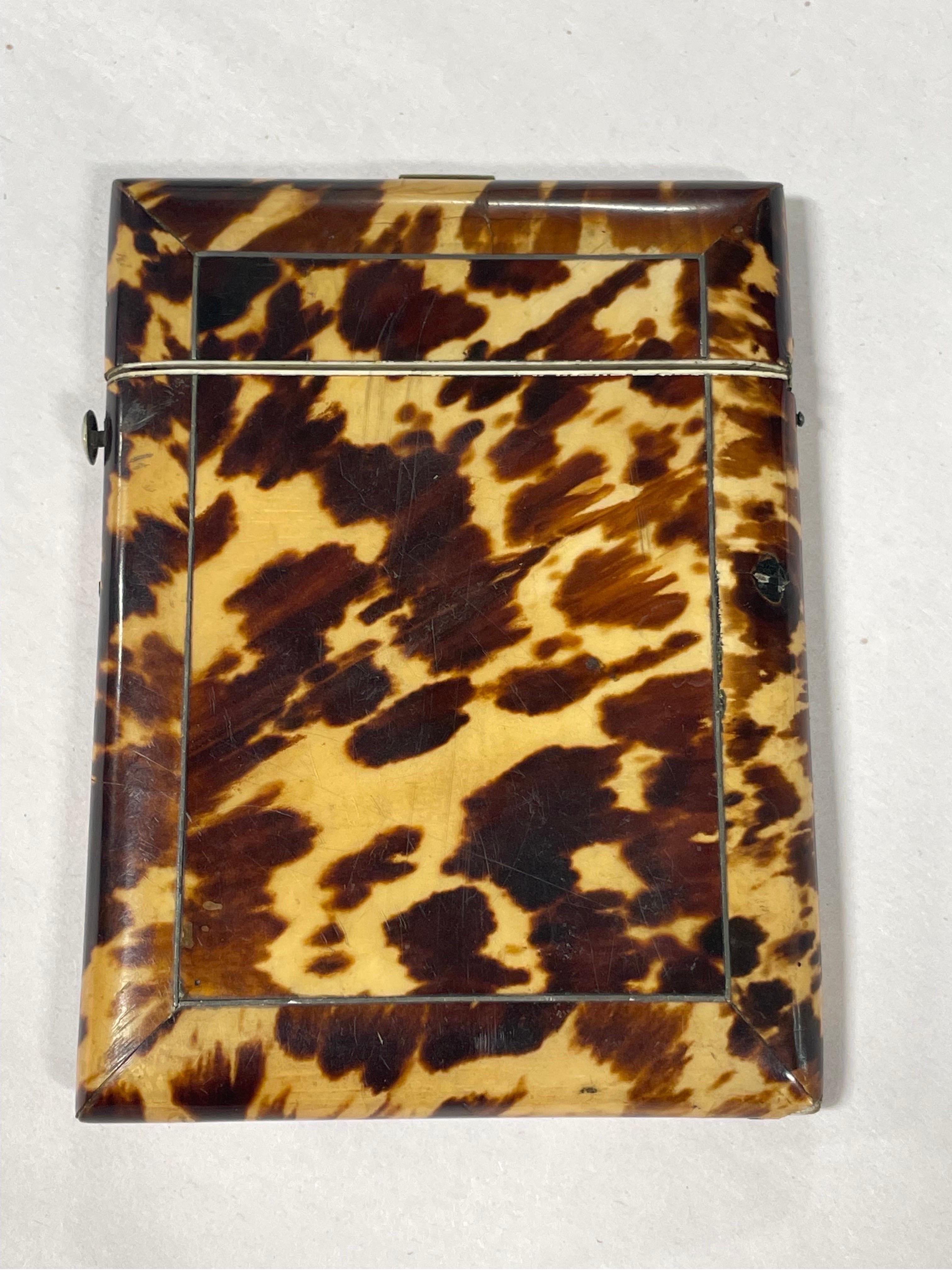 An Antique English blonde tortoiseshell card holder with locking hinge. 
Please view all photographs for damage.
