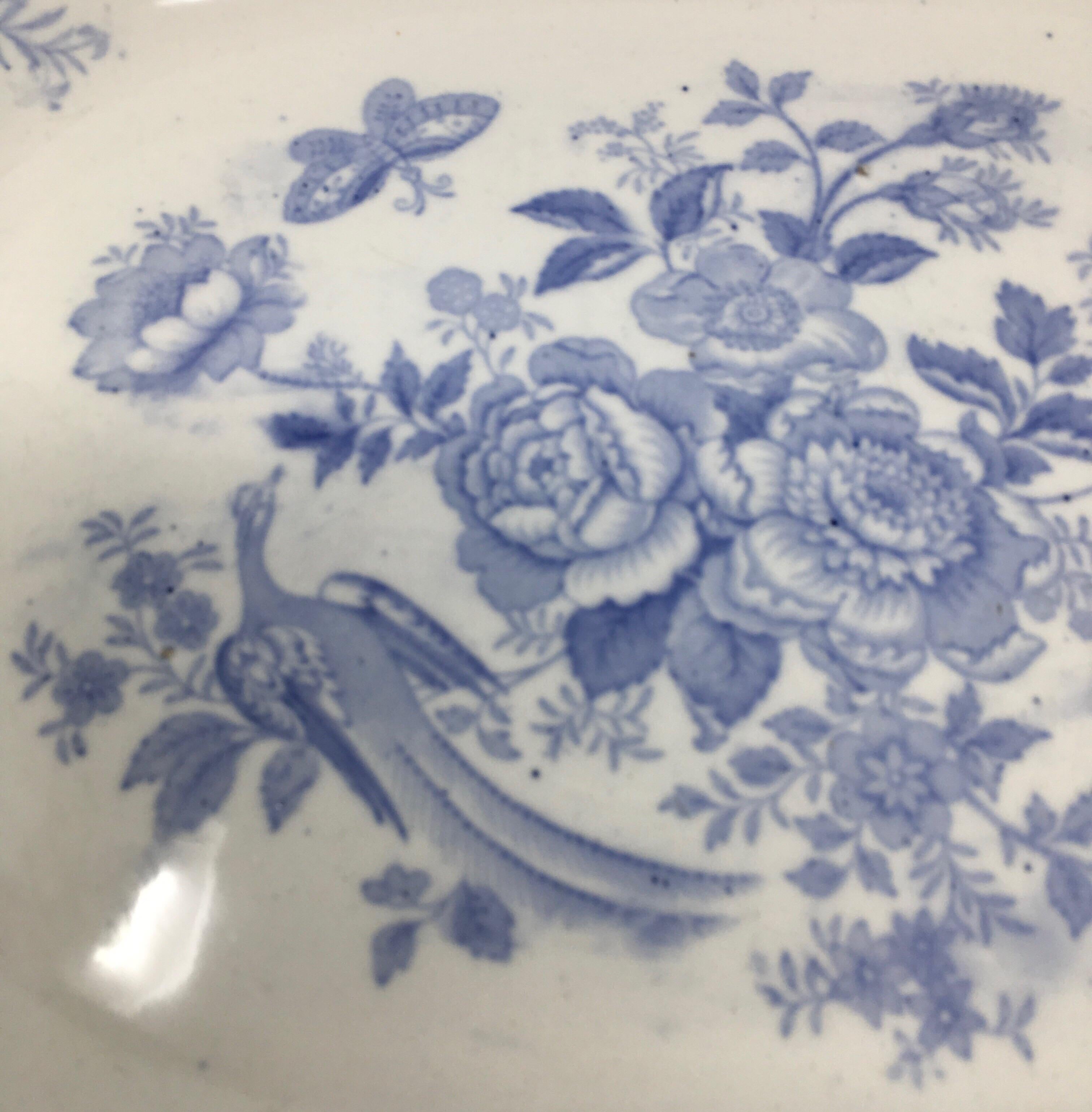 Found in England, this transfer ware platter is in the pattern of Asiatic Pheasants. The platter is in the traditional pale blue and white color palette and bears the makers mark on the underside.