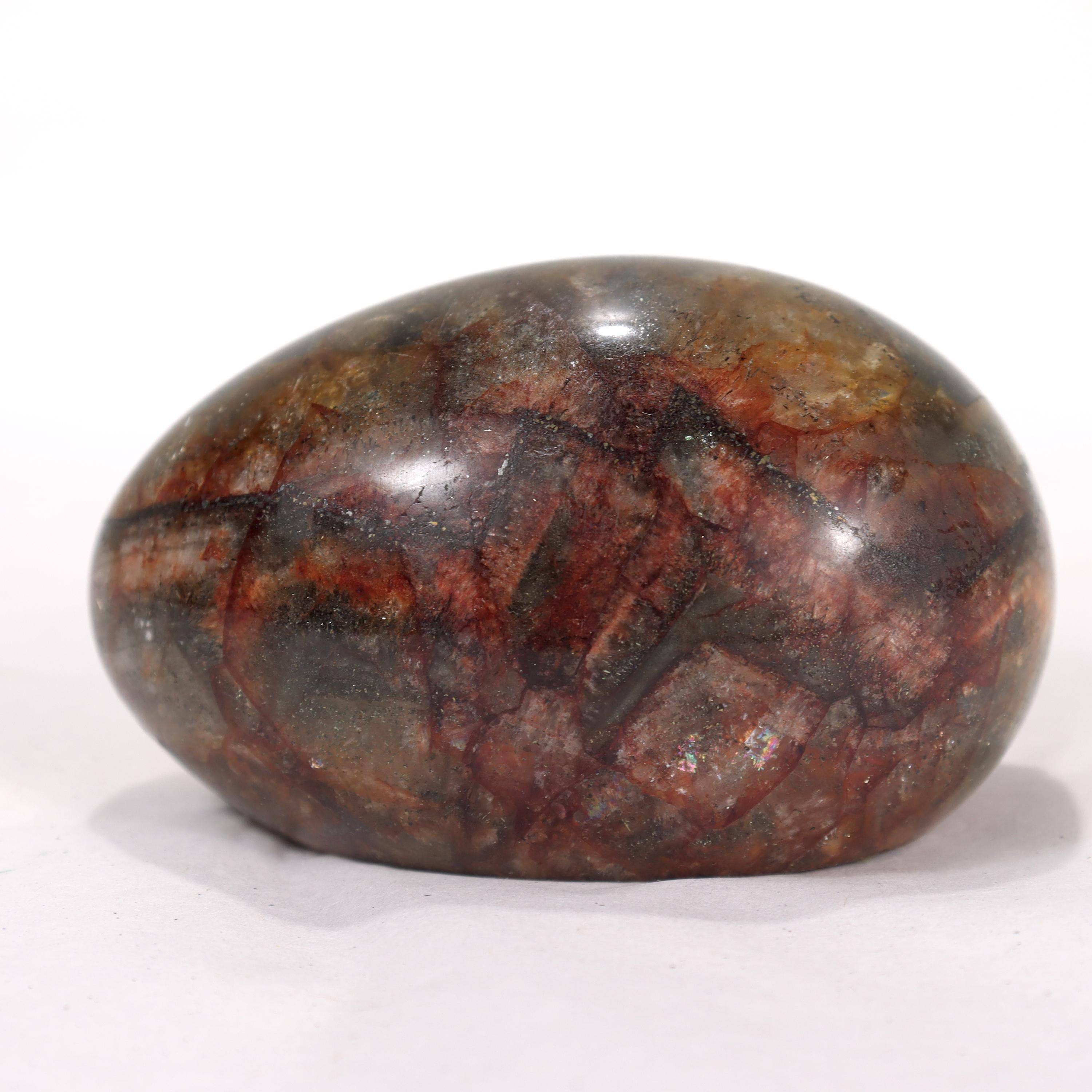 A fine antique paperweight.

Comprised of Blue John (also known as Derbyshire Spar), a rare form of fluorite from England with distinct purple & yellow band patterns.

In an ovoid egg shape with a red felt base.

Simply a great