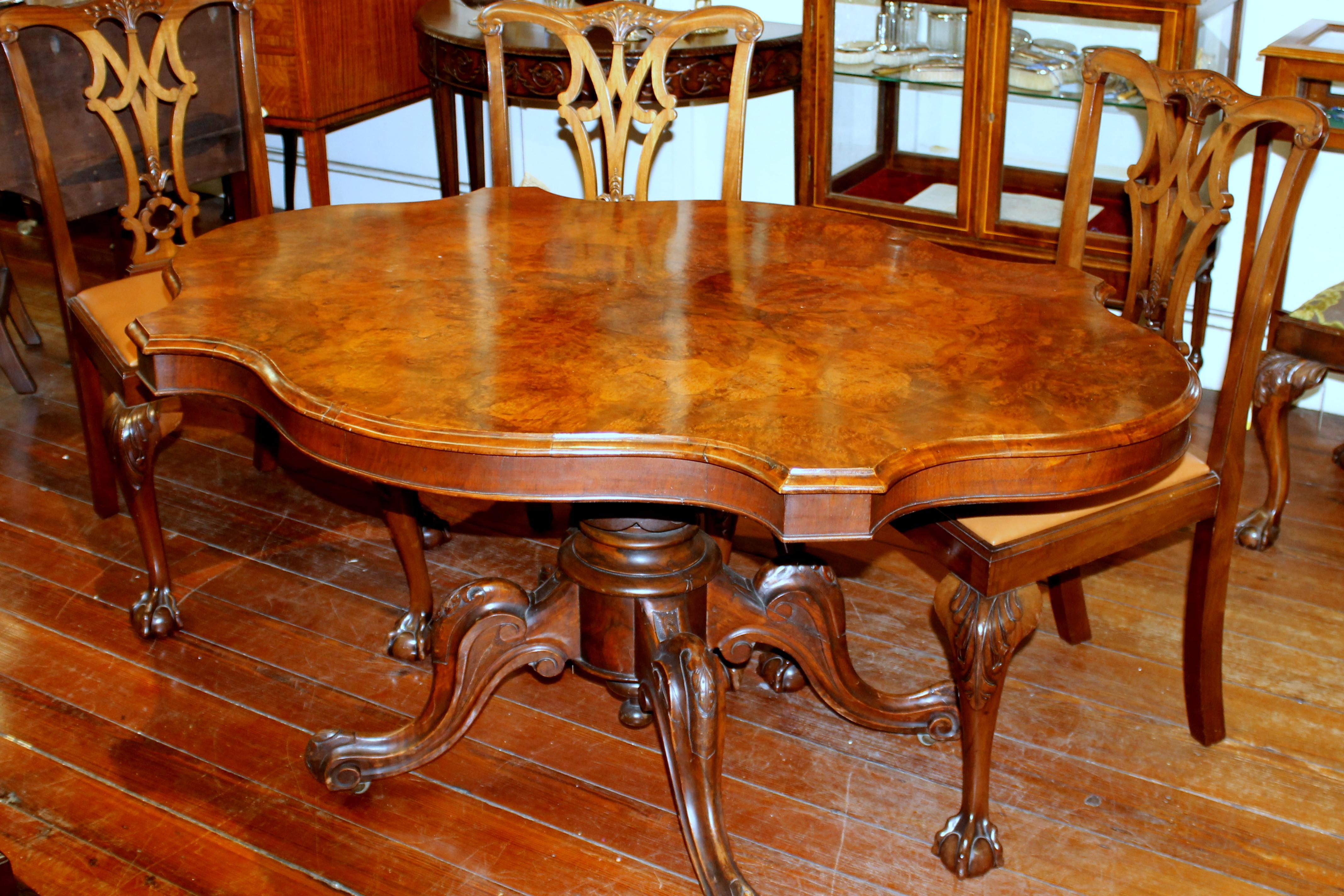 Fabulous quality antique English book-matched burr walnut rare shaped tilt-top loo table for games as a breakfast table or a centre table.

Please note superb carved pedestal and wonderfully figured top. May be kept in an upright tilted position for