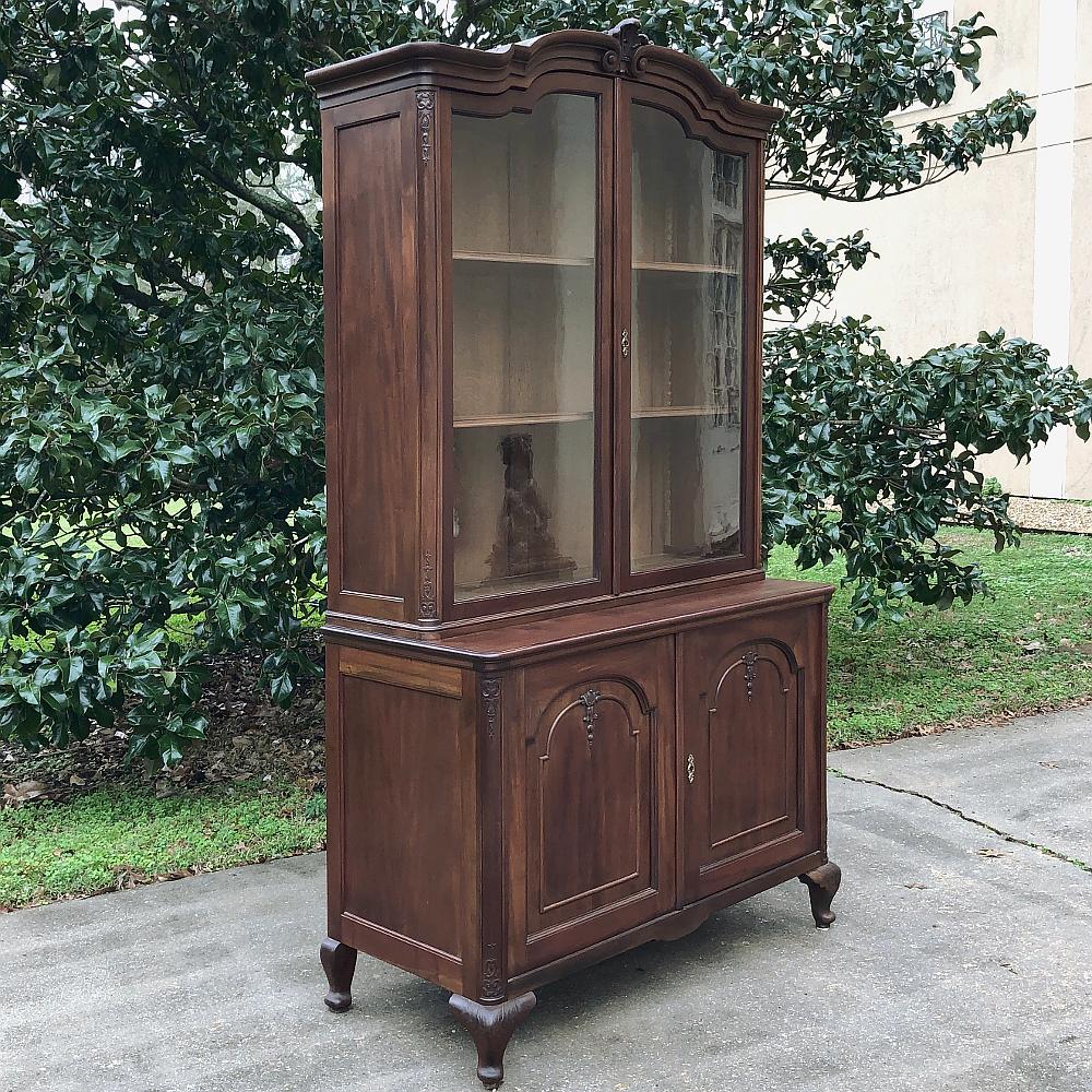Antique English bookcase in mahogany ~ Queen Anne Style represents a tailored elegance that will display your books or collection with a flair that will provide the perfect accent to your room! Generous upper glazed tier with arched crown is