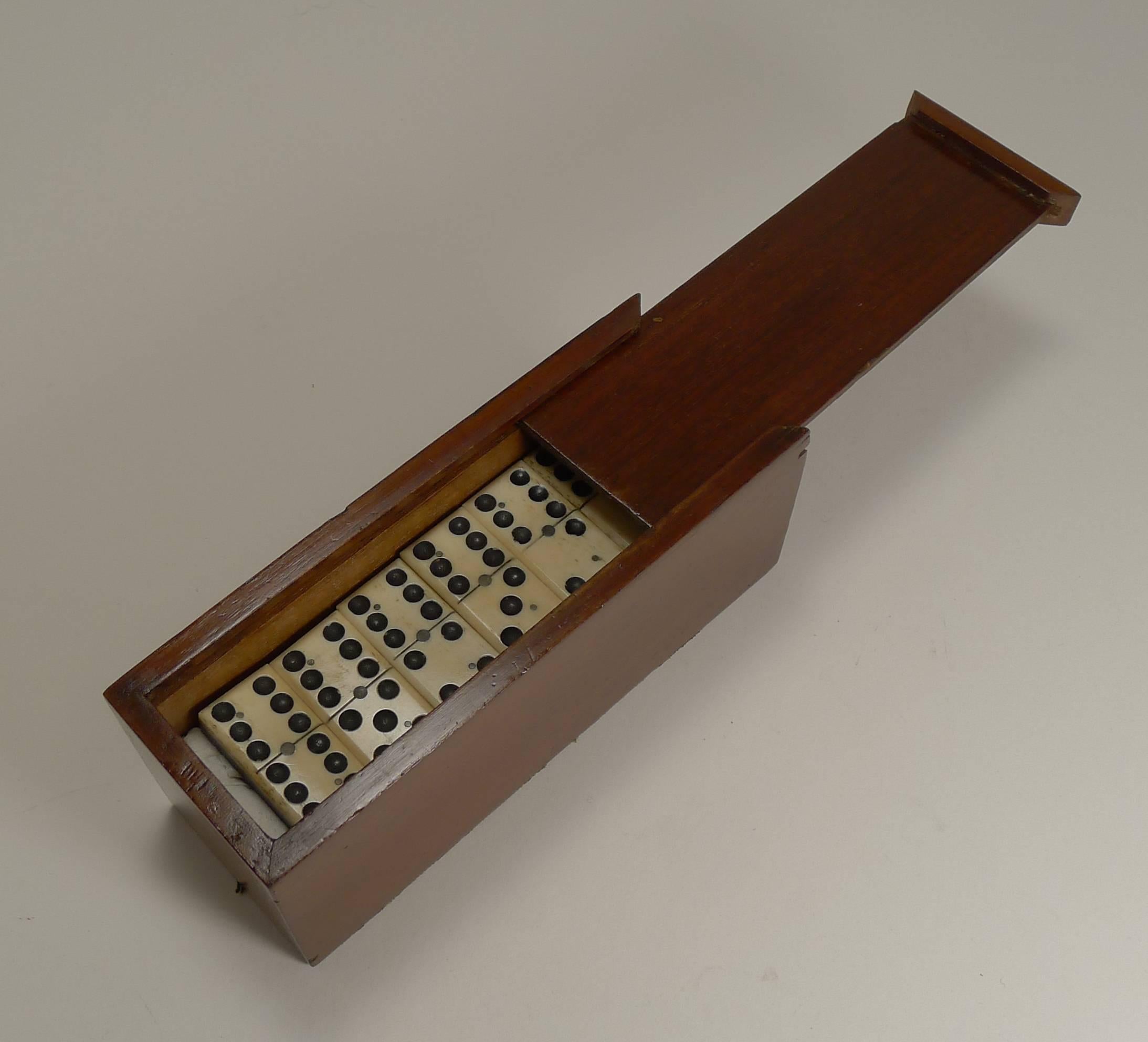 A charming set of late Victorian dominoes or dominos, all in wonderful condition with a handsome polished wooden storage box with a sliding lid.

Dating to circa 1890, the set is better than most with a quality finish, each Domino with canted
