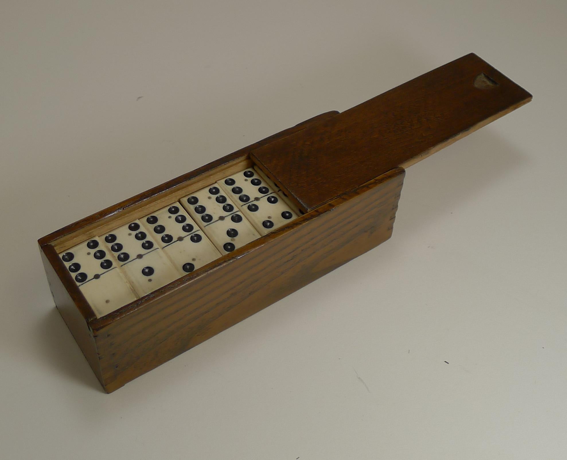 A charming set of late Victorian dominoes or dominos, all in good condition with a handsome polished wooden storage box with a sliding lid.

Dating to circa 1900, the set is better than most with a quality finish, each Domino with canted edges,