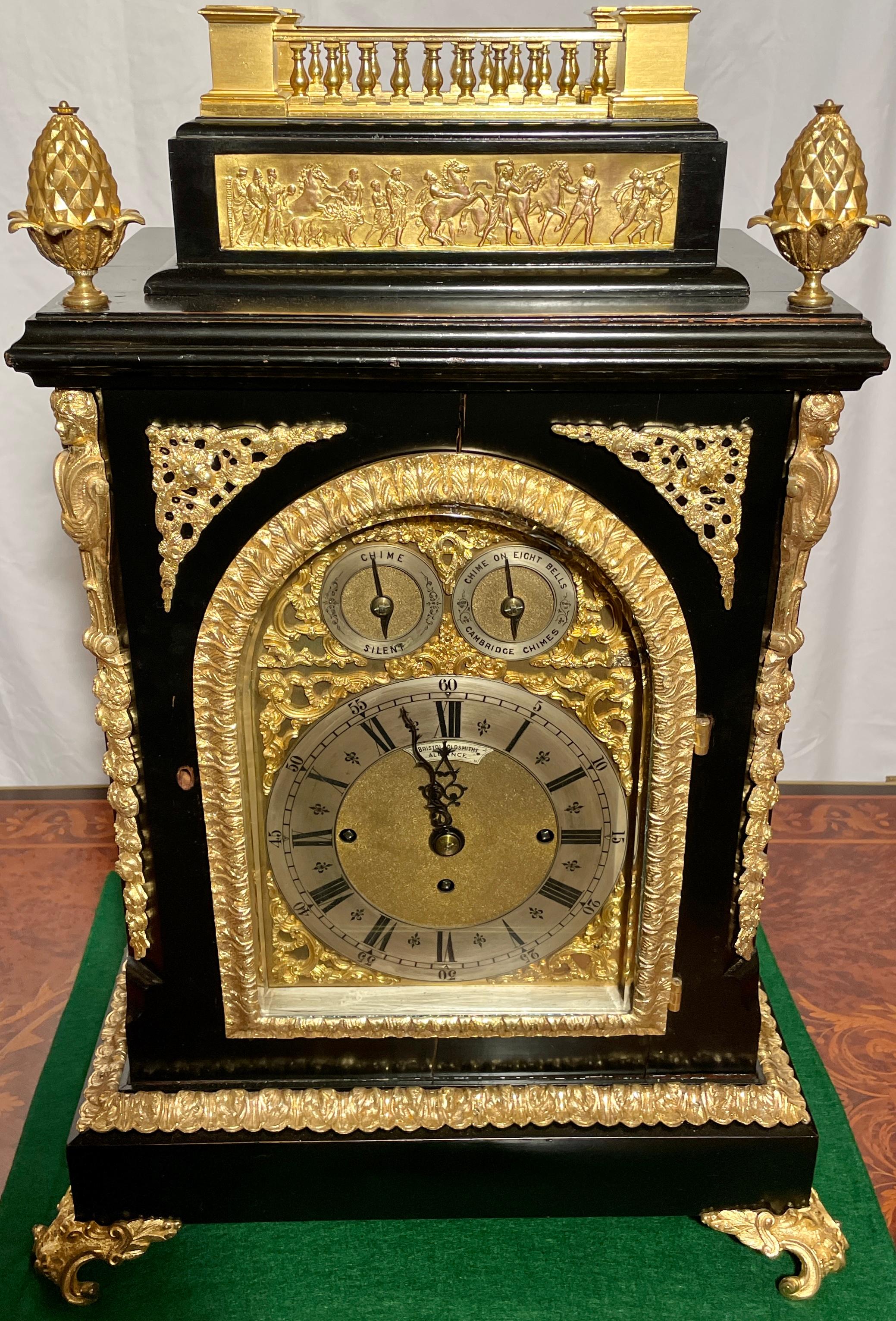 Magnificent antique English gold bronze and ebonized wood bracket clock with triple fusee chiming on eight bells, circa 1880.