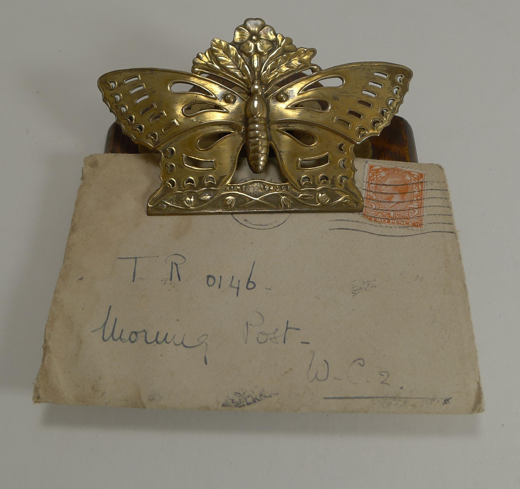 A wonderful Victorian desk-top letter clip with a solid Oak backing and the hinged clip made from brass in the form of a wonderful butterfly.

The hinge is strong and very usable and the perfect for business cards or keeping letters and papers in