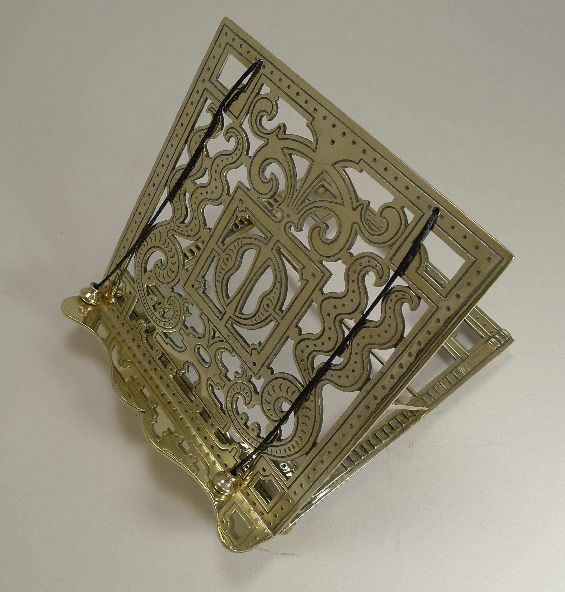 A beautiful English brass book stand made from solid cast brass, the central pierced panel having decorative engraving

The stand's angel can of course be adjusted and even lays flat, standing on four ball feet. The back is where the makers mark