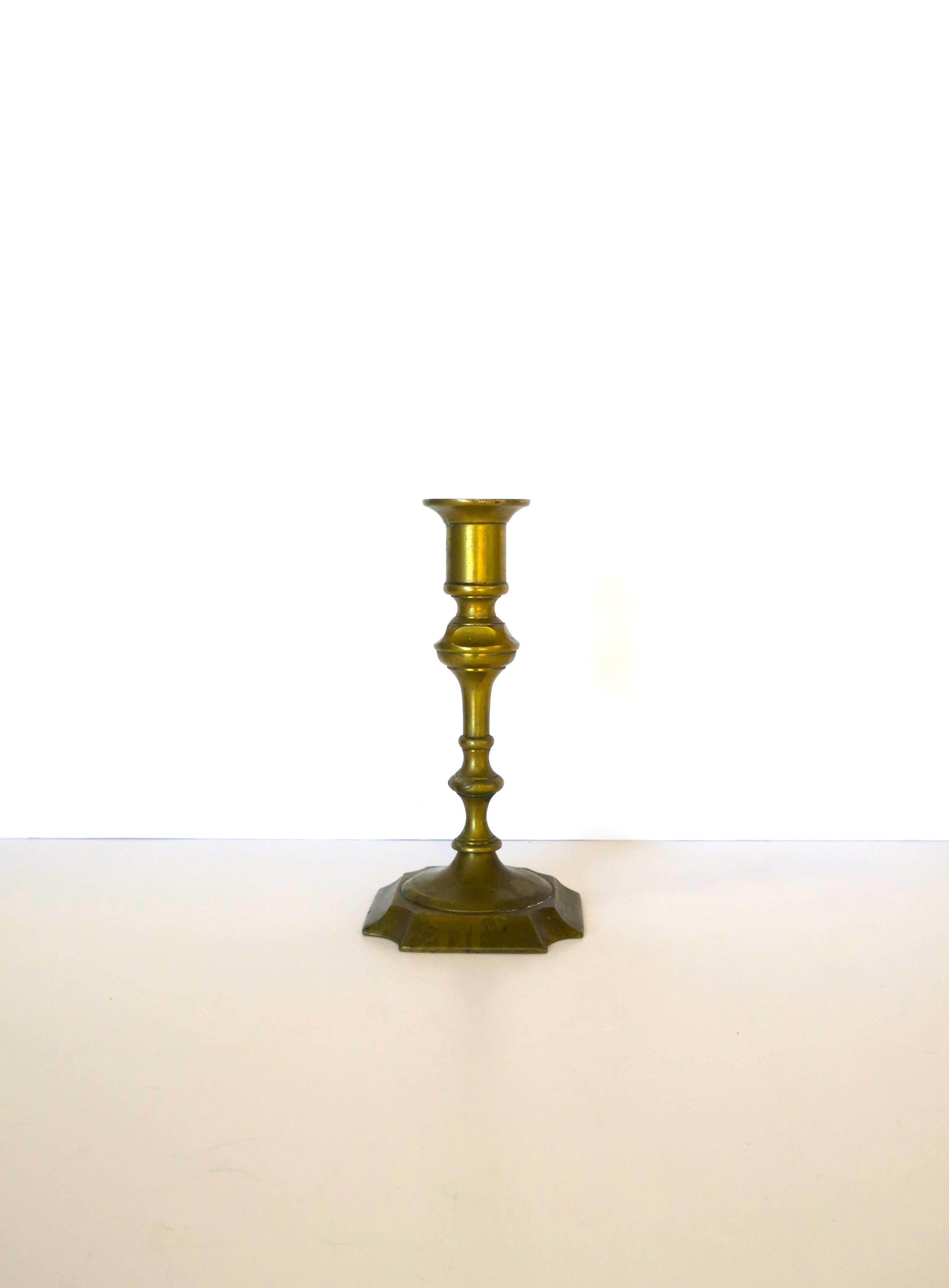 An authentic English brass candlestick holder, circa 18th-19th century, England. Candlestick is solid brass. Piece is marked on bottom 'Made in England', as shown in last two images. A beautiful candlestick holder with age patina intact