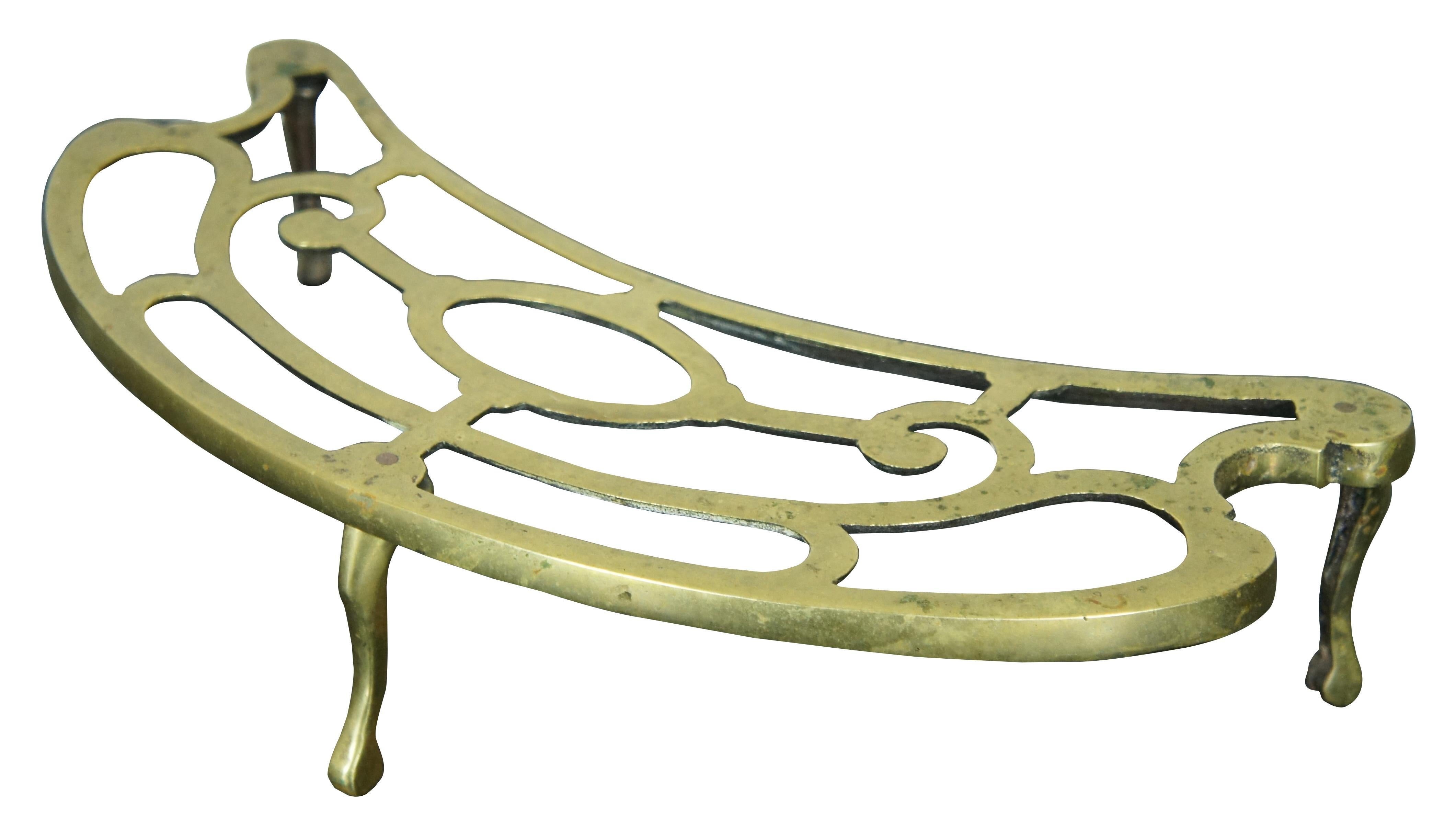 Antique demilune pierced brass footman or fireplace trivet / plant stand supported on three cabriole style feet. Size: 18