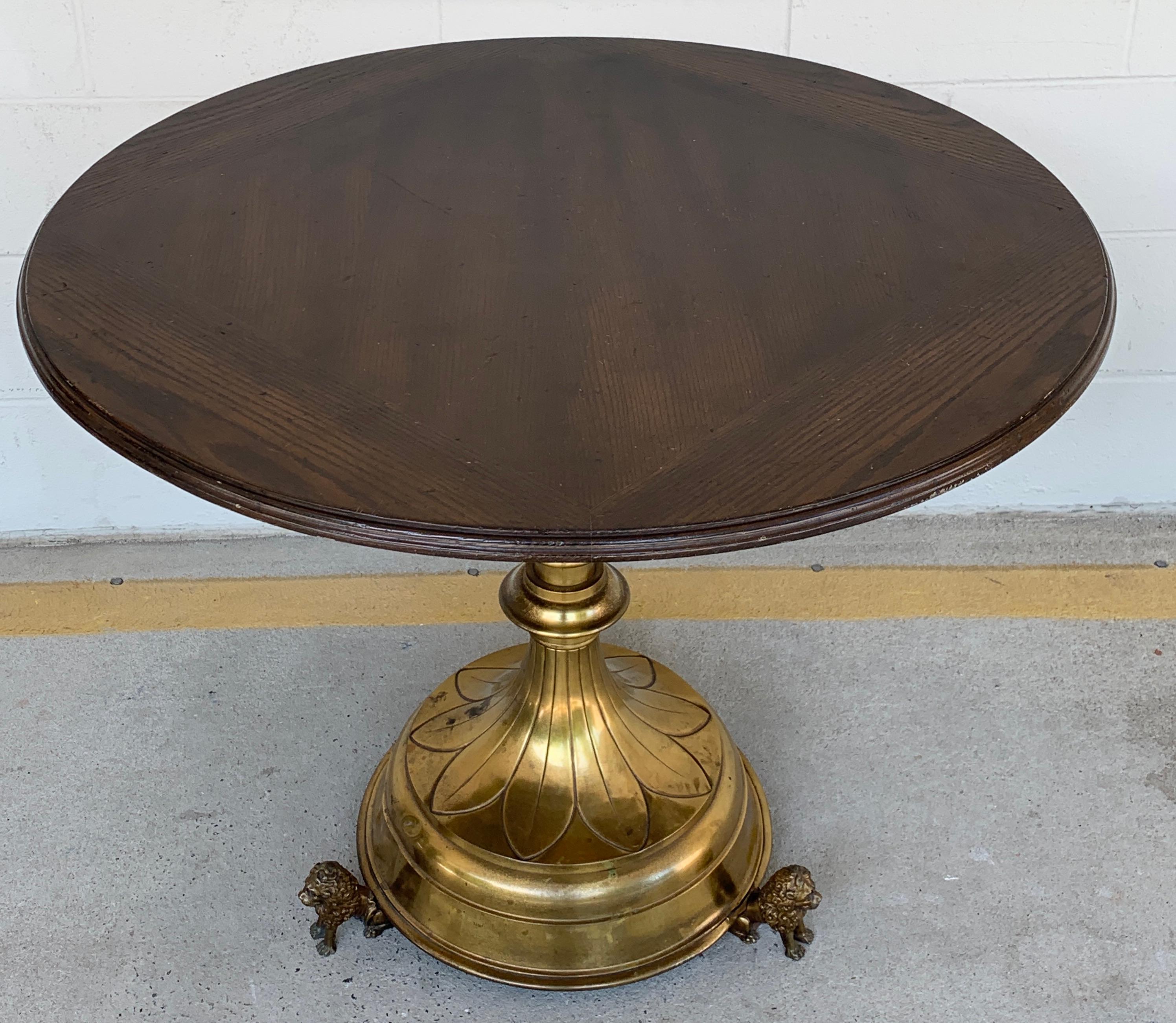 Antique English brass and mahogany lion motif pub table, with circular 35.5