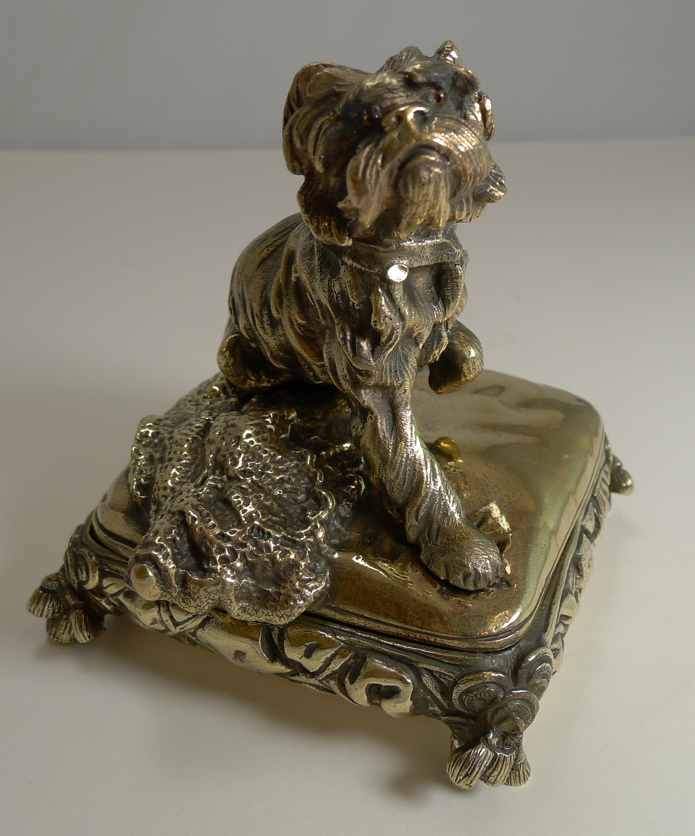 An absolutely charming Victorian novelty jewellery box made from very heavy cast brass and I think that the dog himself is Bronze, with traces of the original gilding.

The sweet little pooch sits on a tasselled cushion with a blanket by his side.
