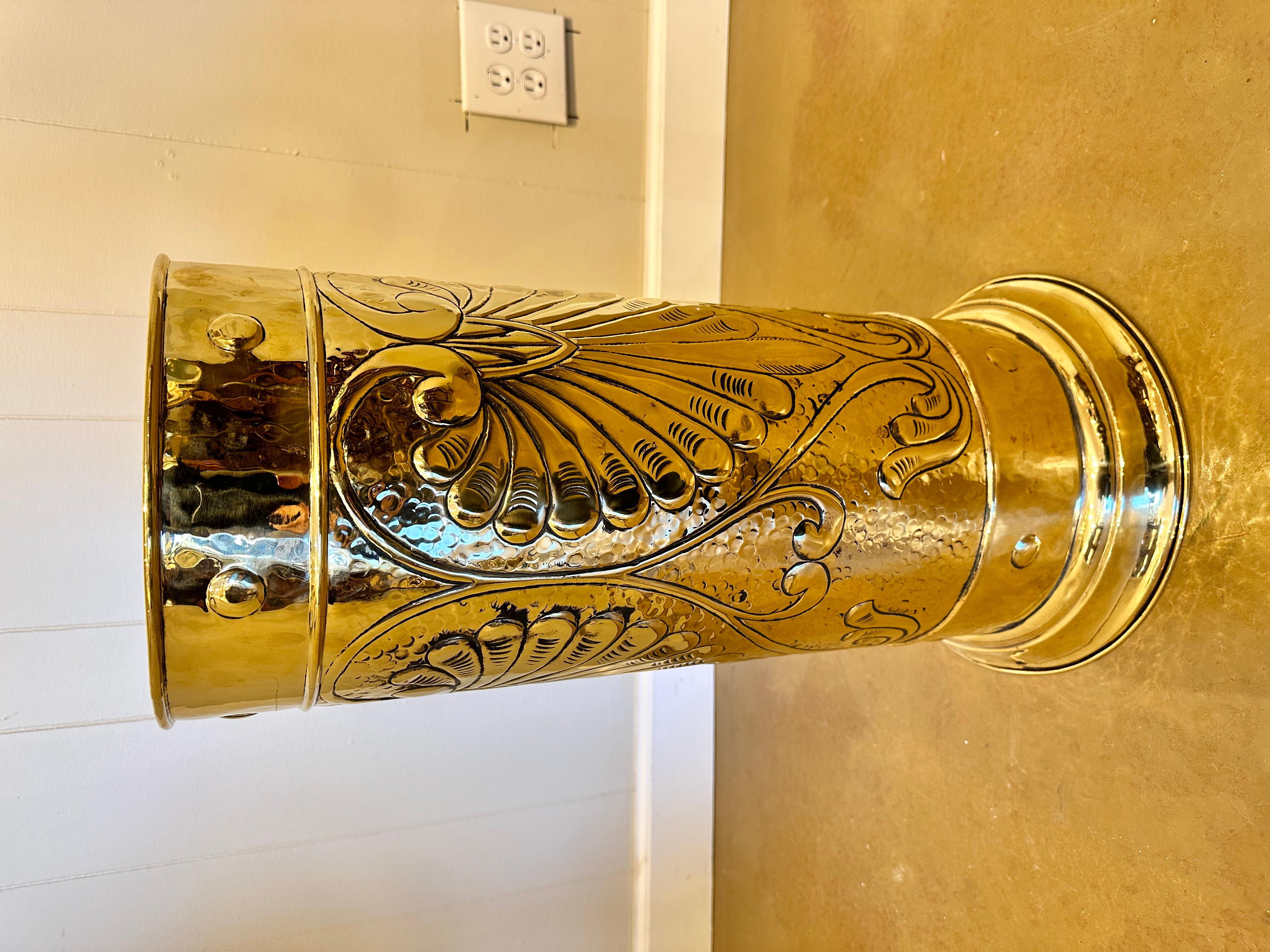 This is a gorgeous English umbrella stand. The brass is in excellent condition and shines beautifully, while also boasting its antiquity in with a lovely patina. The design is slightly raised adding ornamentation as well as texture to this piece.