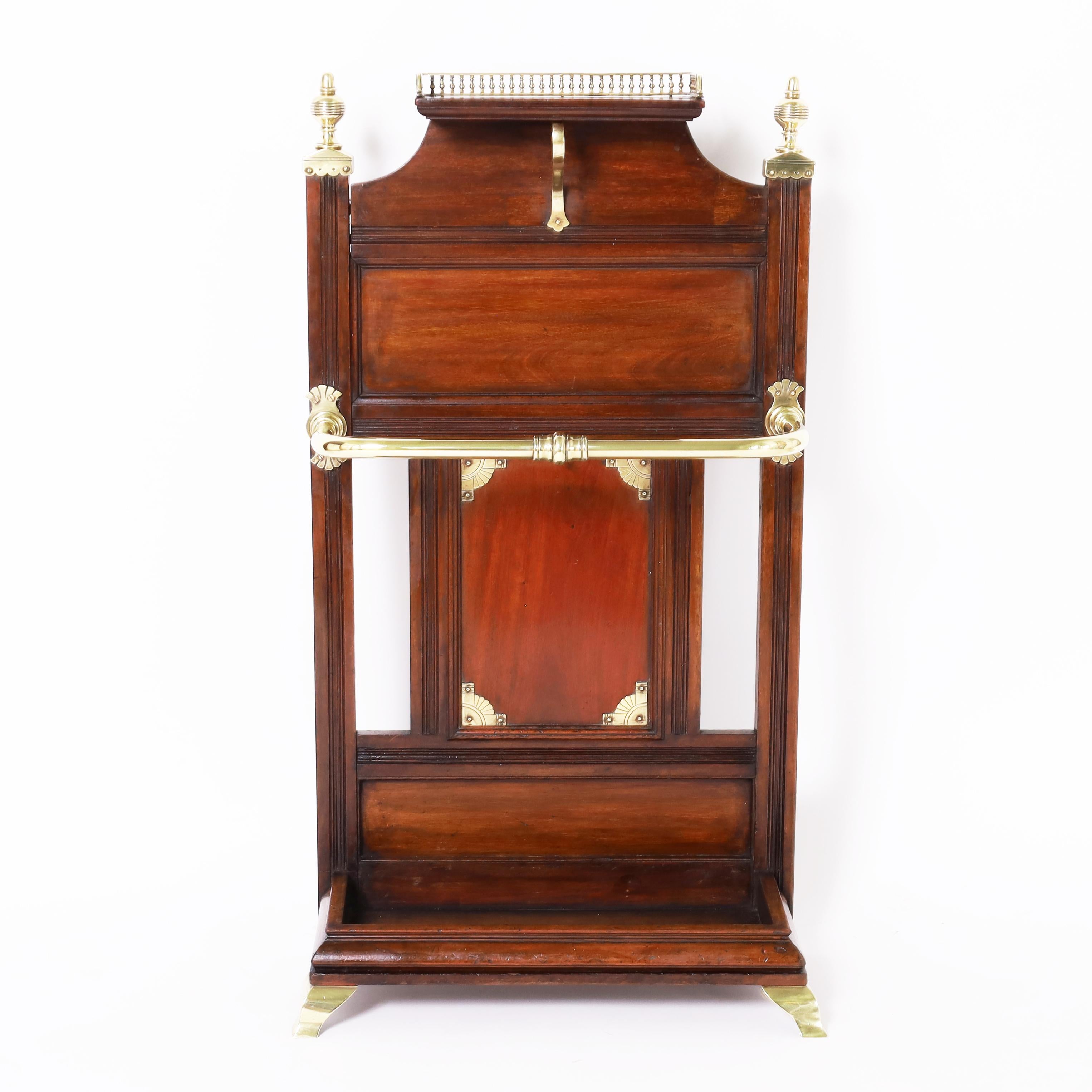 Magnifique porte-canne ou porte-parapluie pour homme de la colonie britannique du XIXe siècle, fabriqué en acajou dans le style Eastlake, avec une galerie en laiton au sommet. Finitions en laiton, barre et consoles sur un fond en bois et une auge
