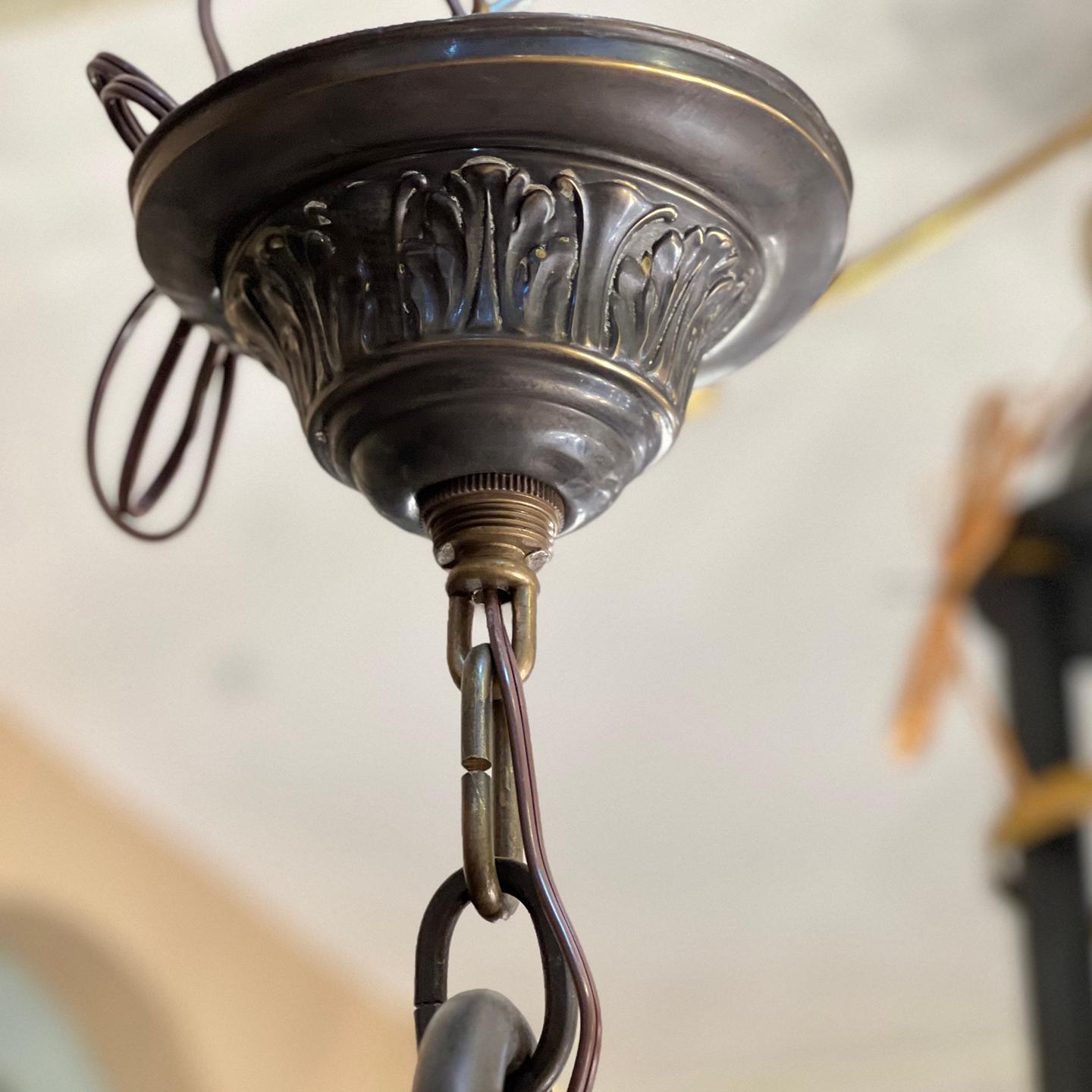 Circa 1900's English bronze chandelier with 6 etched glass globes and interior lights.

Measurements:
Height: 37