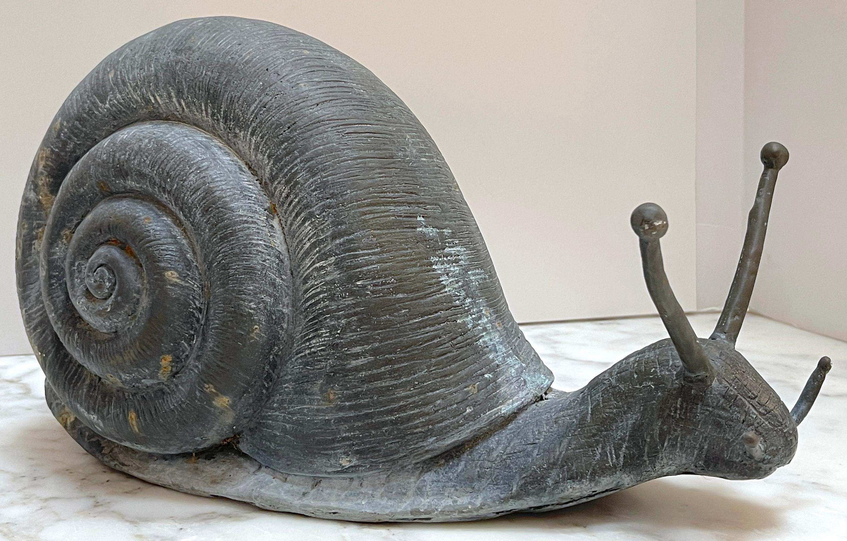 Antique English Bronze Garden Snail Sculpture 
England, 20th Century

Antique English Bronze Garden Snail Sculpture, a striking piece from 20th-century England. This sculpture is masterfully cast and intricately detailed, capturing the essence of a