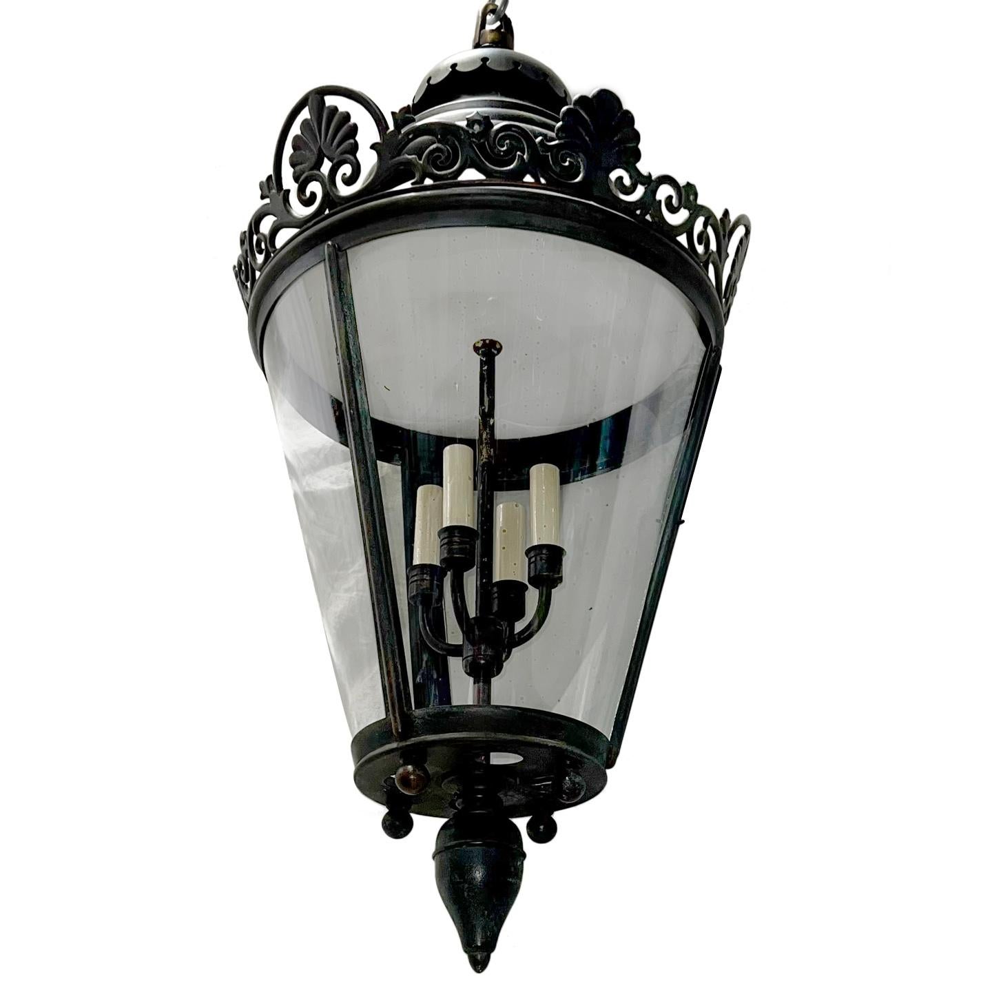 A circa 1900's English patinated bronze lantern with 4 interior lights.

Measurements:
Present drop: 38