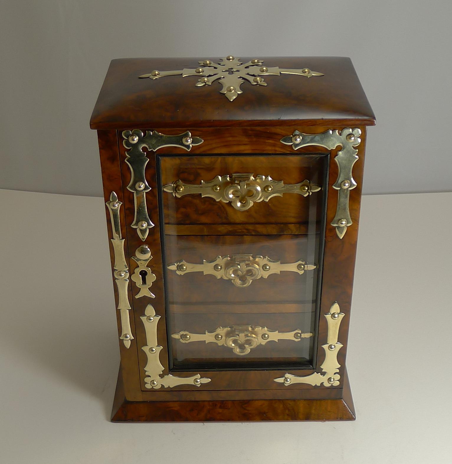 An unusual and very elegant jewelry box made from a beautiful and rich burl walnut.

The box is beautifully decorated with the original polished brass and gilded brass mounts including shaped swing handles to the to the front of the three