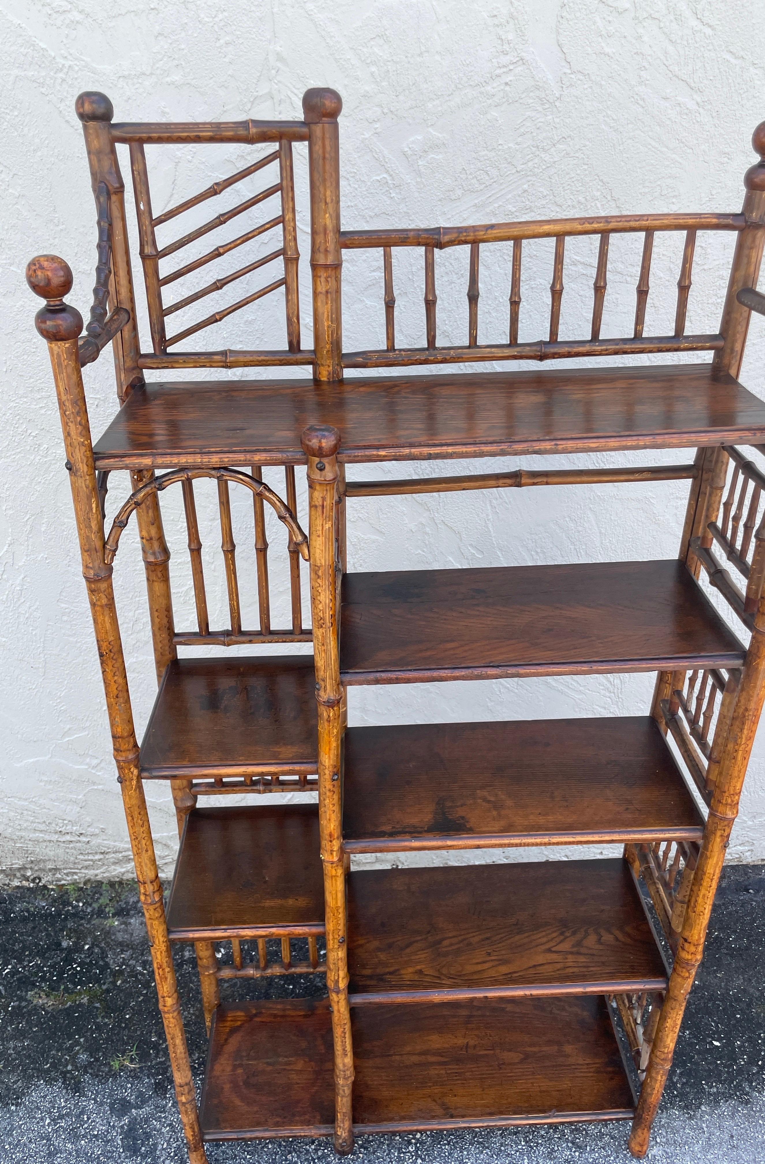 Antique English burnt bamboo etagere with great detail and multiple shelves / compartments. In very good and sturdy condition.