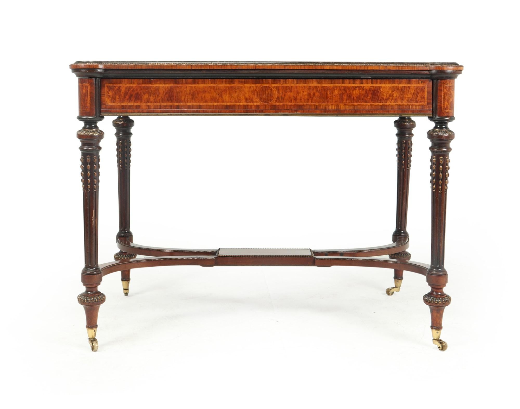 A lovely antique burr walnut writing table produced in England around 1880 in the manner of Louis XVI furniture, great quality inlay and brass mounts, single drawer with hand cut dovetail joints turned and reeded leg and finished with castors, great