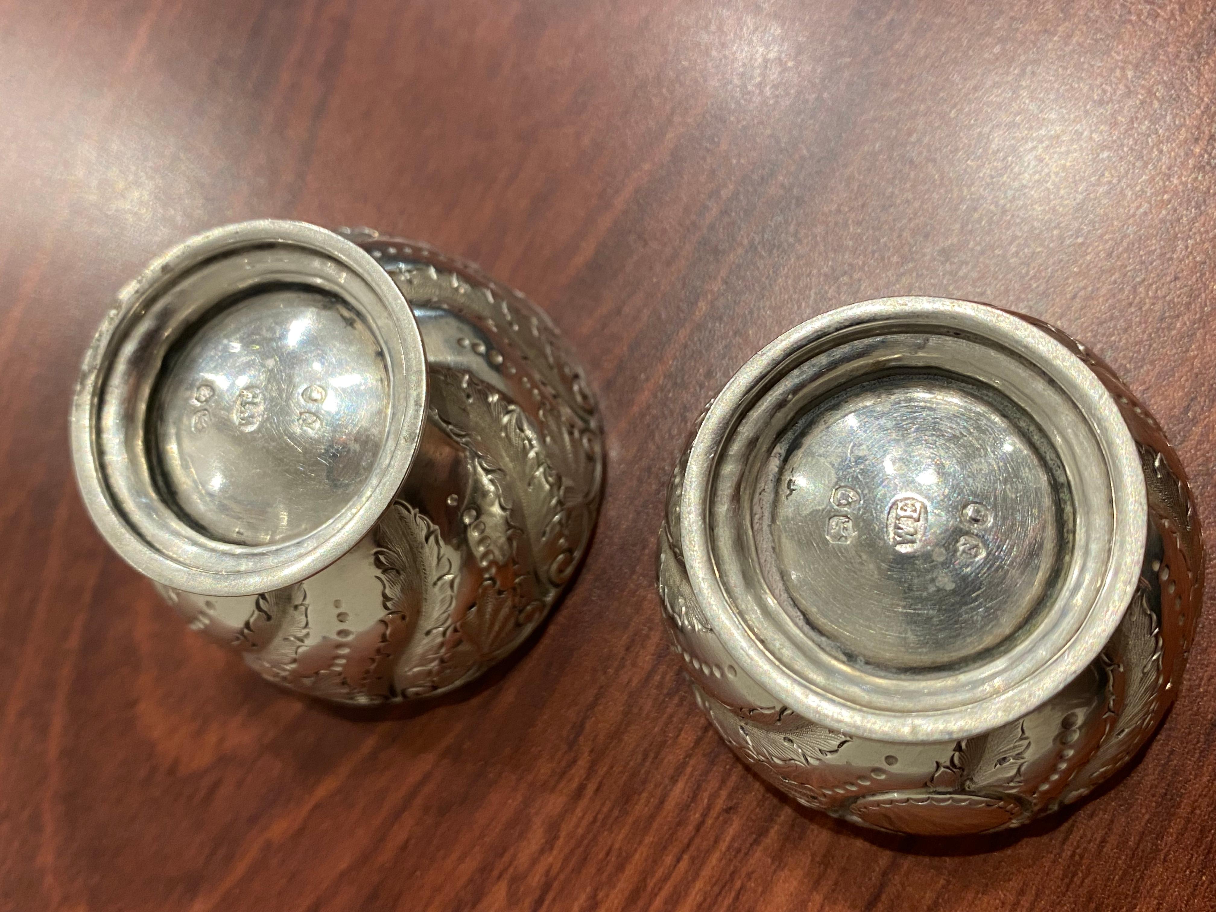 Finely embossed throughout, 

this pair of antique Sterling Silver 

salt & pepper cellars date from Victoria era

 

Circular footed,

with London hallmarks to the base, 

also bearing maker’s mark W.E. – for William Evans

letter date for 1888 –