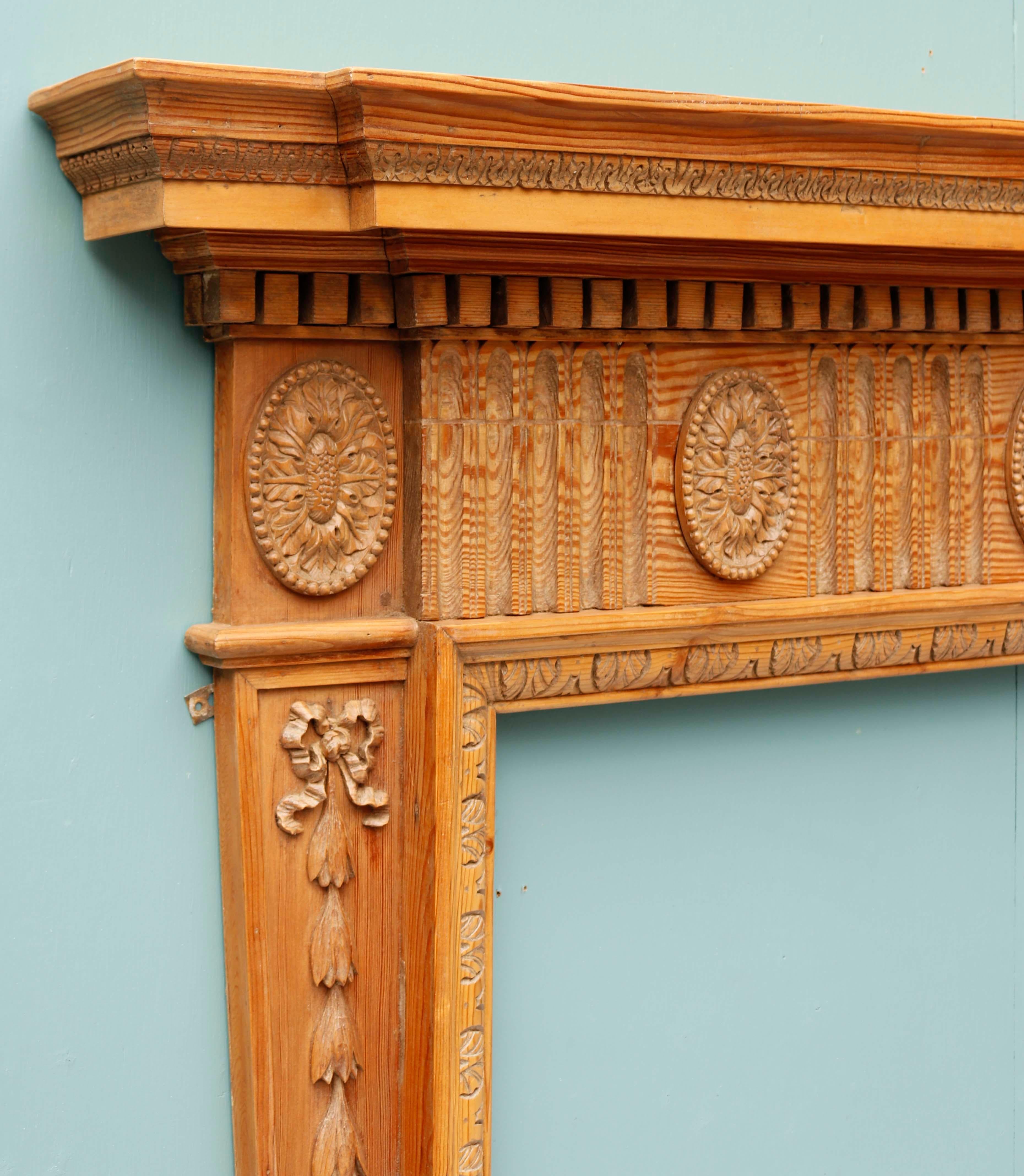 Antique English carved fireplace. An early 19th century English carved fireplace. With bell flower detailing along both jambs and intricate carved frieze.

Additional Dimensions

Opening height 98 cm

Opening width 111.5 cm

Across the foot
